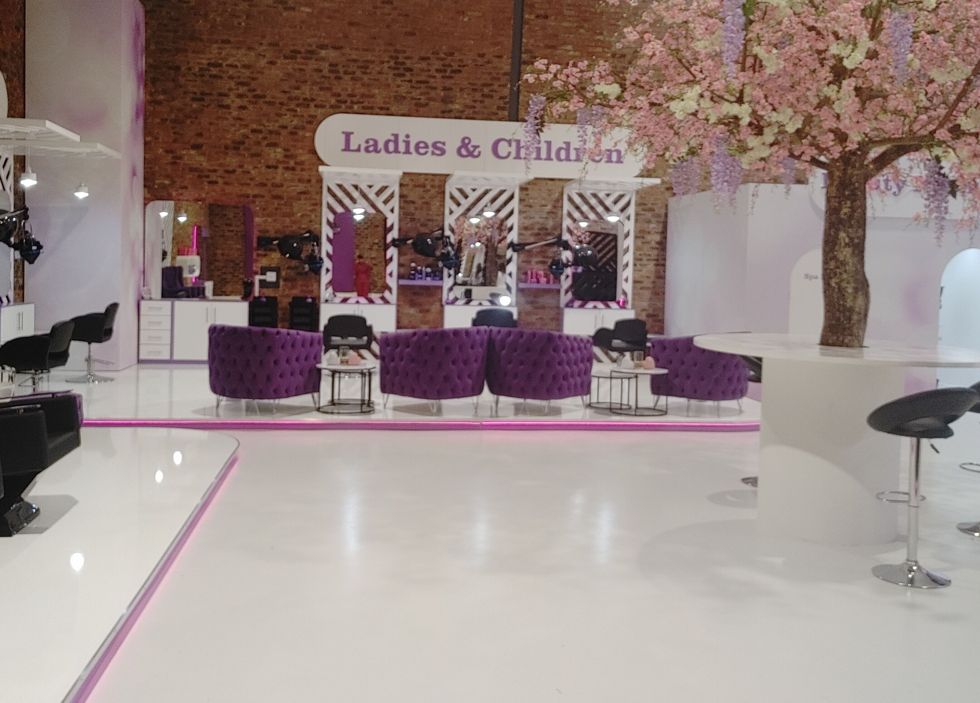 Modern salon interior at Volumicious Riversands, Johannesburg, Gauteng, ZA. Plush seating and elegant decor.