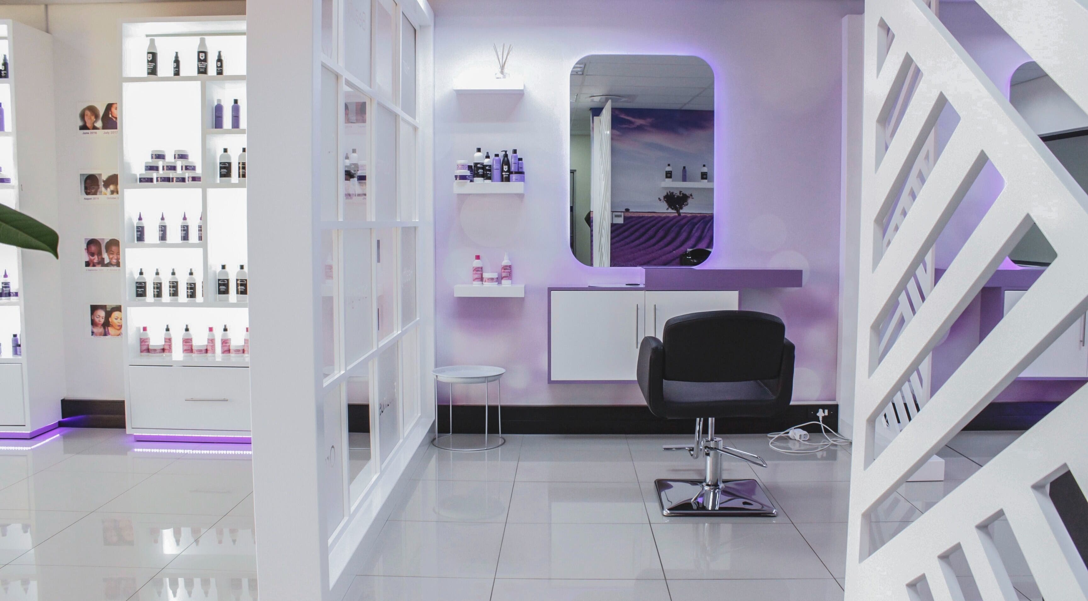 Modern salon interior at Volumicious Randburg, Randburg, Gauteng, ZA, featuring sleek styling chair and product shelves.