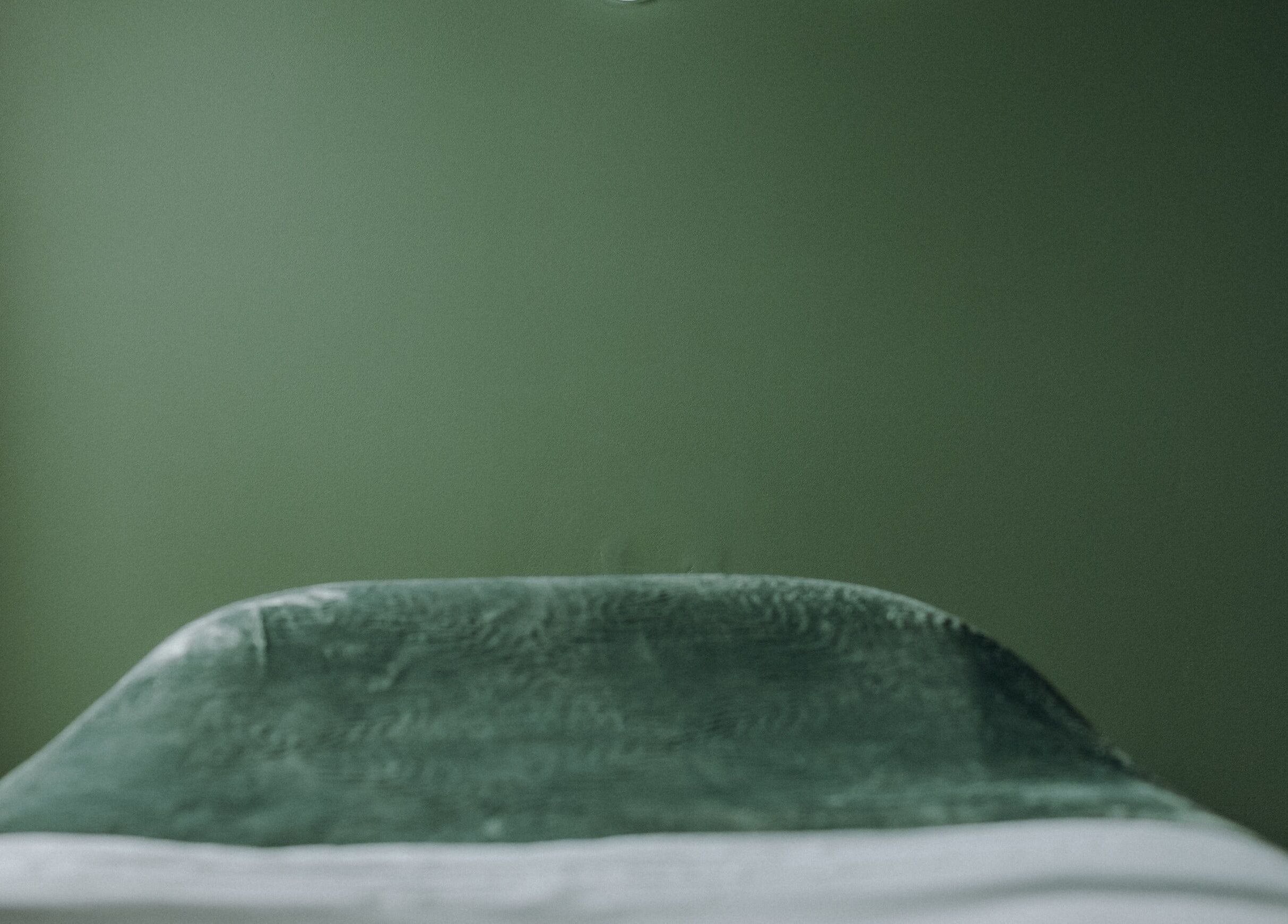 Calming massage room with green decor at Massage by Ash, Kaiapoi, Canterbury, NZ.