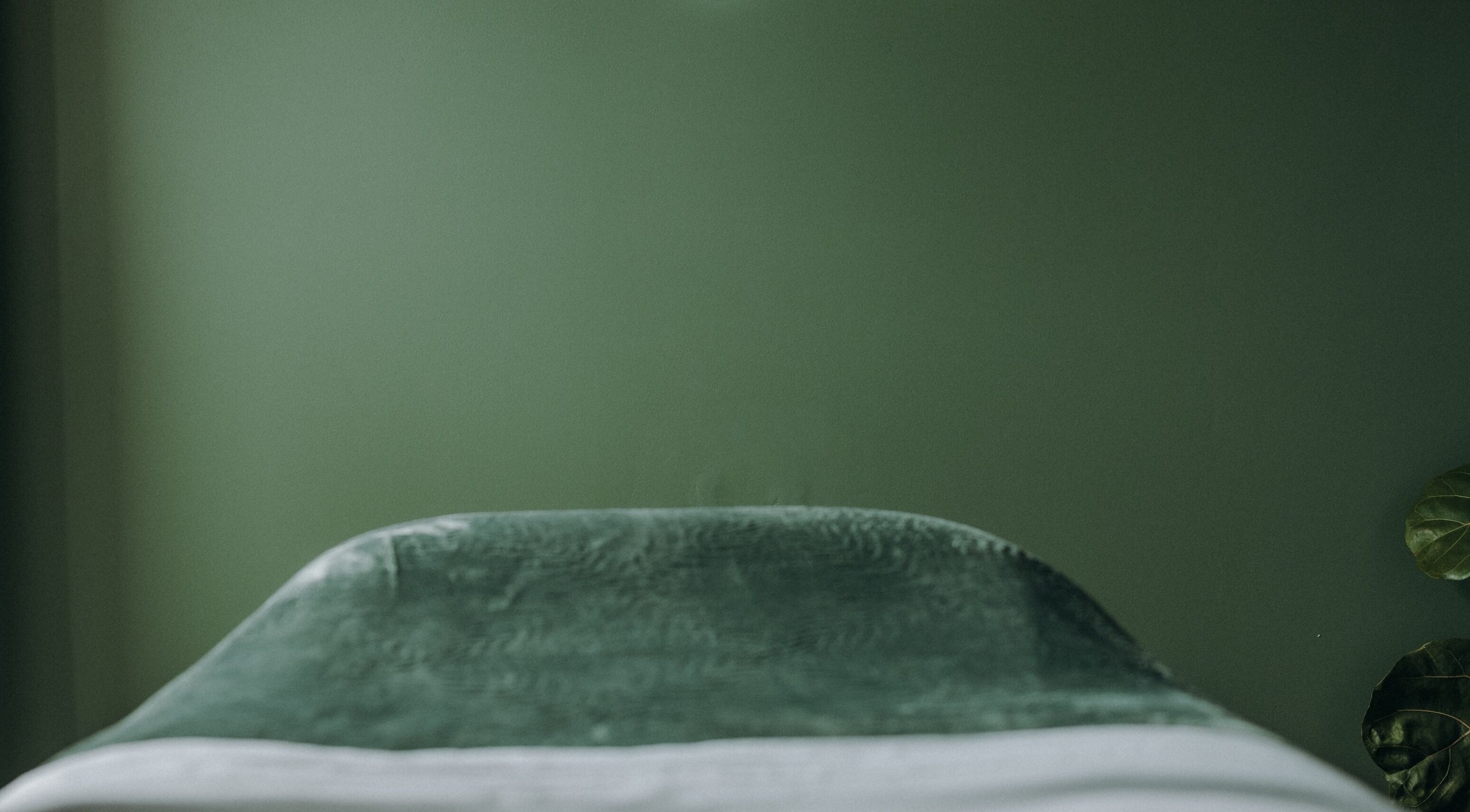 Calming massage room with green decor at Massage by Ash, Kaiapoi, Canterbury, NZ.