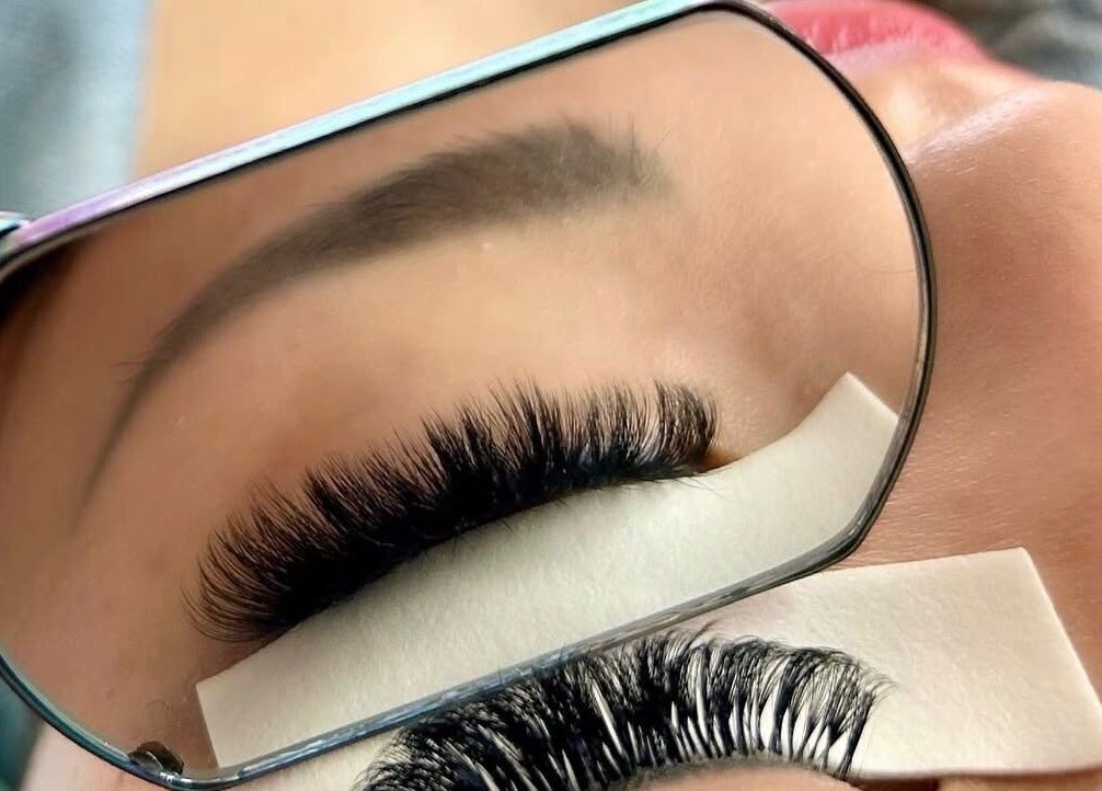 Beautiful eyelash extensions at Missmango.lashes (Angelica), Red Deer, Alberta, CA, expertly styled and reflected in mirror.
