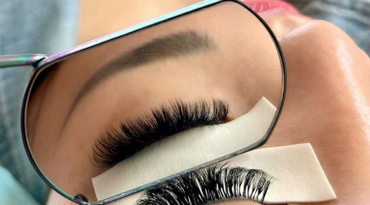 Beautiful eyelash extensions at Missmango.lashes (Angelica), Red Deer, Alberta, CA, expertly styled and reflected in mirror.