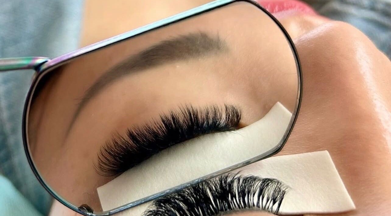 Beautiful eyelash extensions at Missmango.lashes (Angelica), Red Deer, Alberta, CA, expertly styled and reflected in mirror.