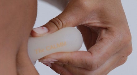 Hand using The Calmm massage tool at Lovedale, New South Wales, AU for relaxation therapy.