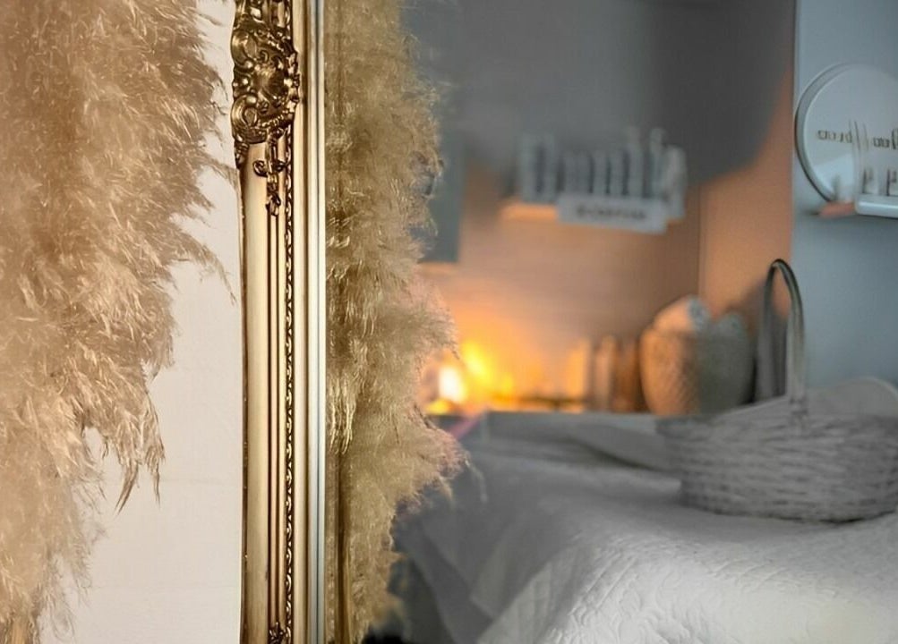 A luxurious room at Skinn Haven, Penrith, New South Wales, AU, with soft lighting, ornate mirror, and plush decor.