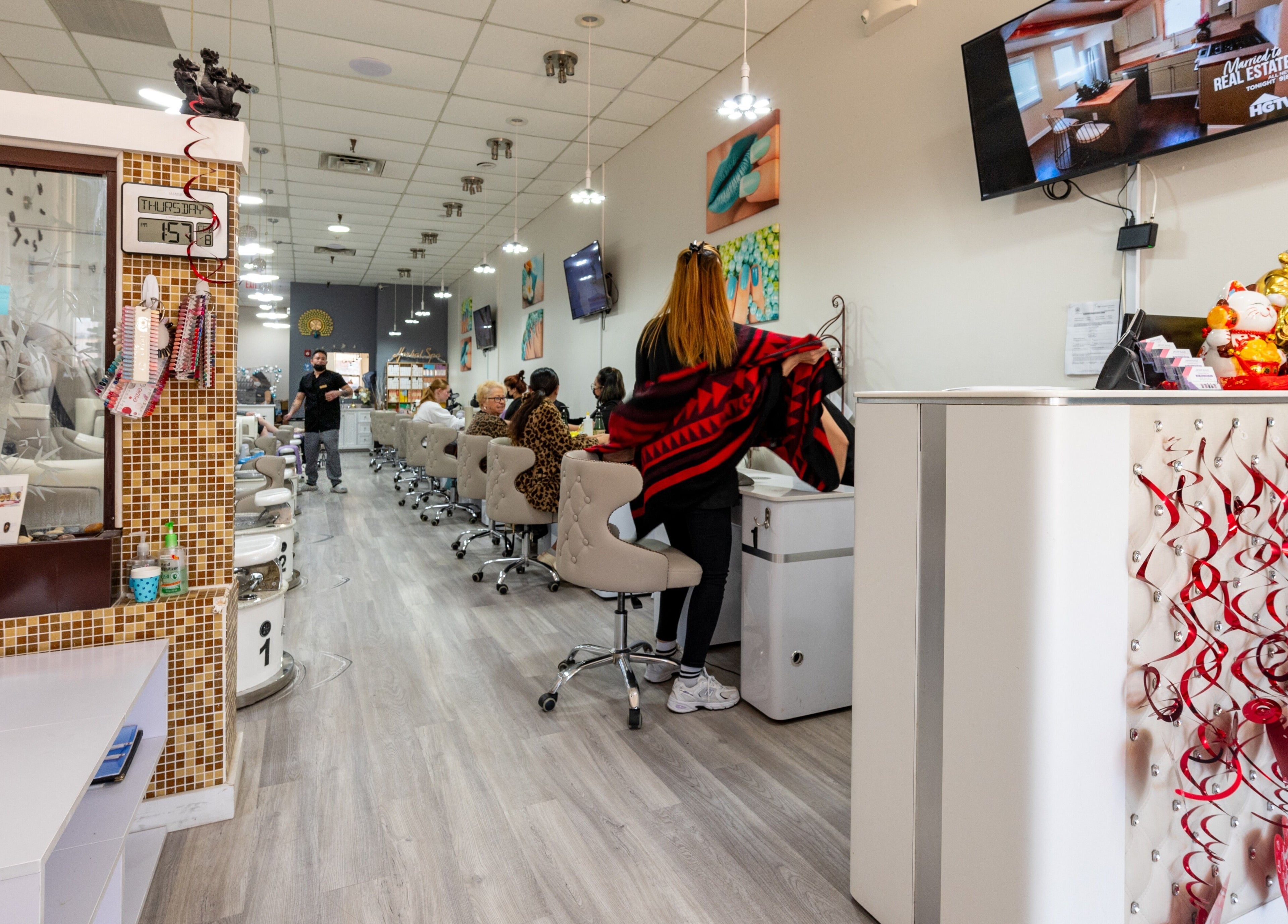 Luxor Nails and Spa interior showcasing modern decor and customer service in North Reading, Massachusetts, US.