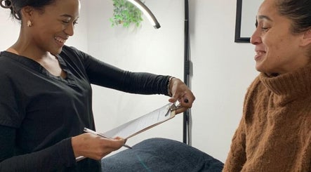 Smiling staff and client consultation at Beauty Collective in Cape Town, Western Cape, ZA.