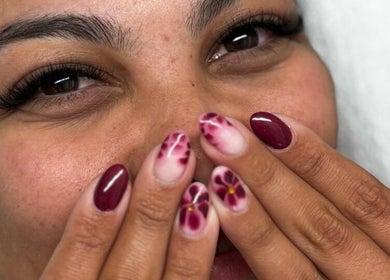 Floral nail art on fingers at Beauty Collective in Cape Town, Western Cape, ZA.