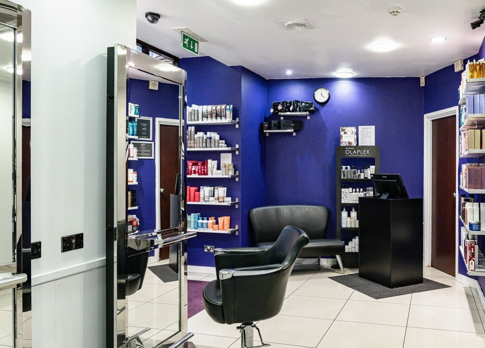 Modern salon interior of Cora Hair with stylish chairs in Birmingham, England, GB.