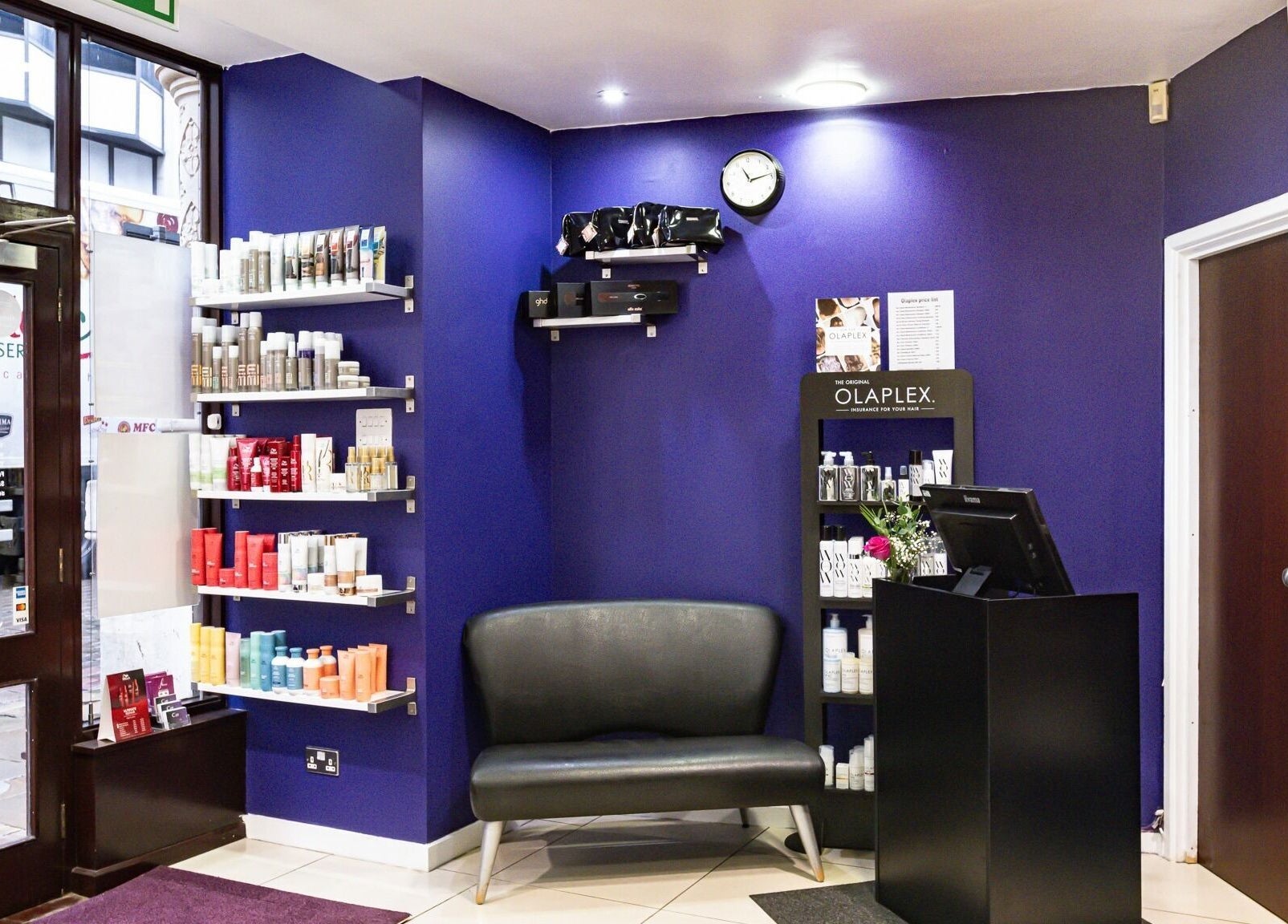 Cora Hair salon entrance with vibrant decor and product display in Birmingham, England, GB.