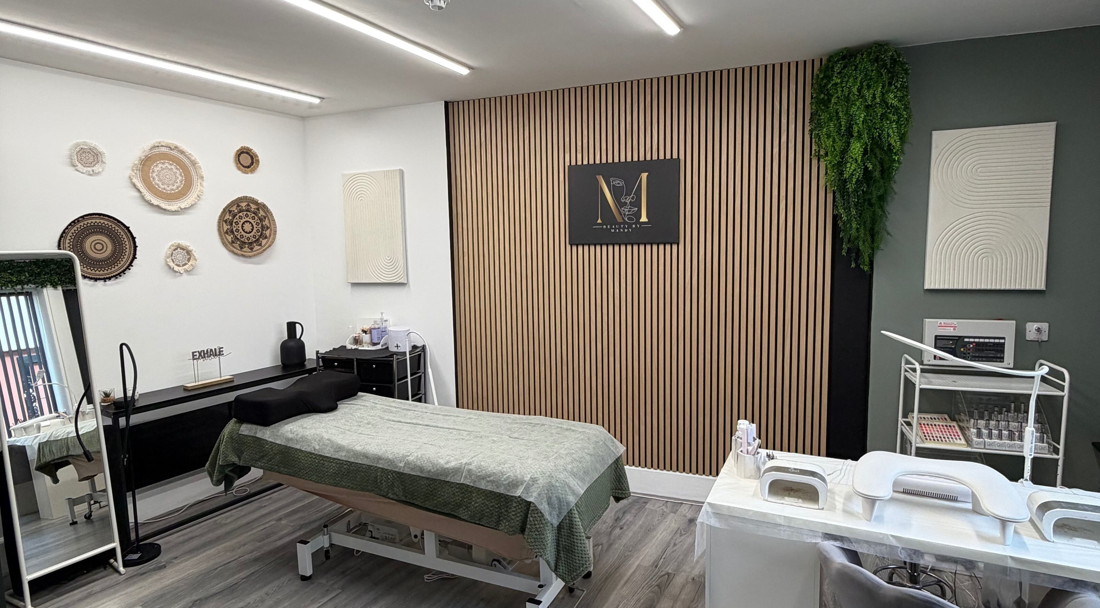 Beauty by Mandy salon interior in Whitehaven, England, featuring a sleek treatment area with modern decor.