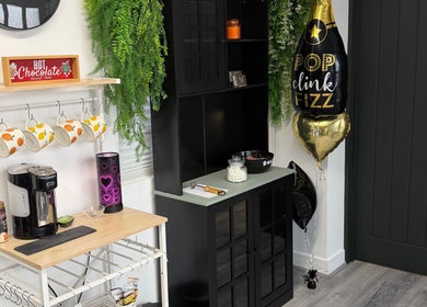 Inviting coffee nook at Beauty by Mandy, Whitehaven, England, GB with mugs and greenery.