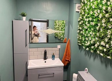 Chic bathroom at Beauty by Mandy, Whitehaven, England, GB, featuring floral wall decor and modern vanity.