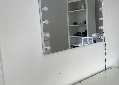 Vanity mirror with lights at NAKD Beauty in Bridgend, Wales, GB, showcasing a chic beauty setting.