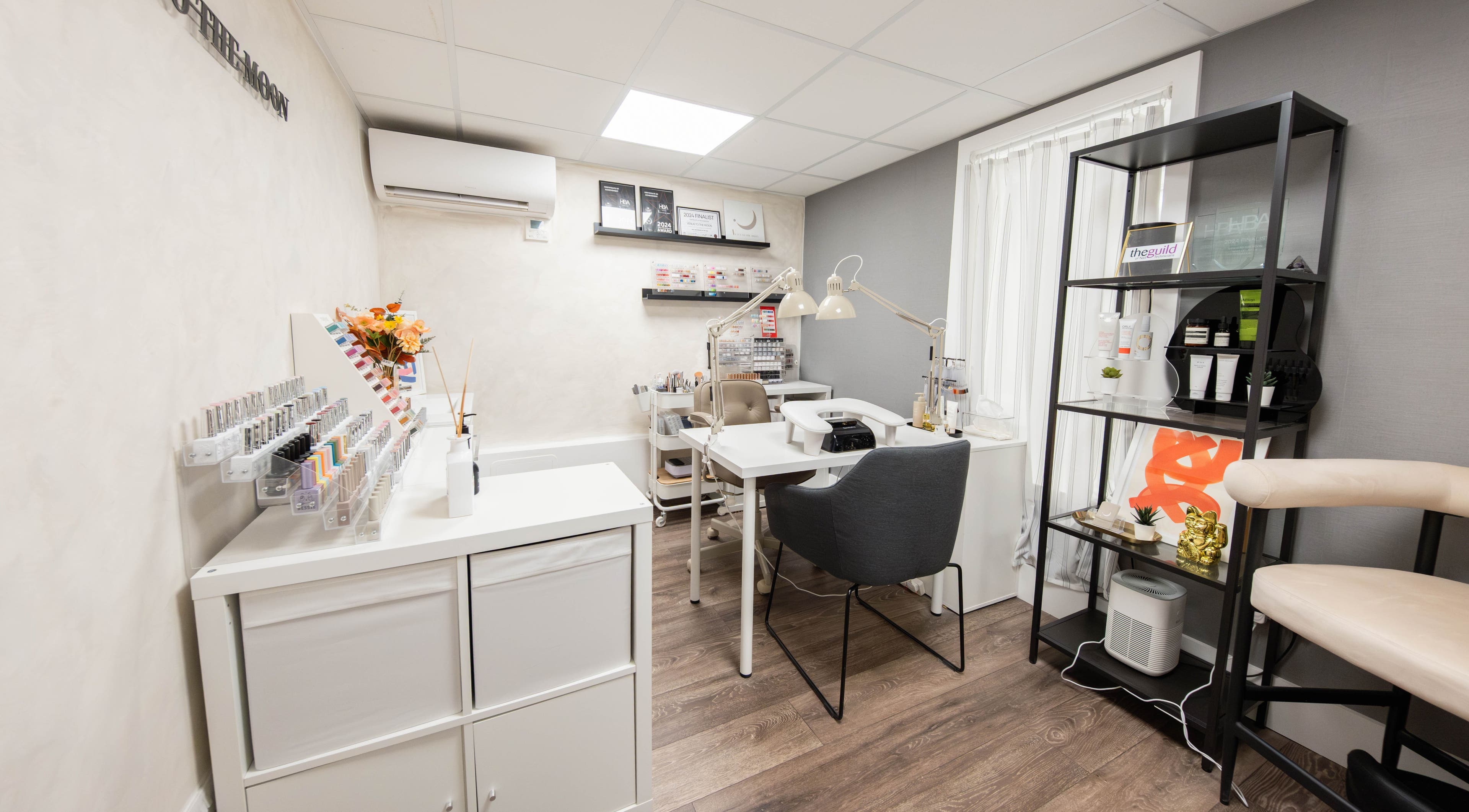 A modern beauty station at Venus to the Moon, London, England, GB, featuring nail polish and decor.