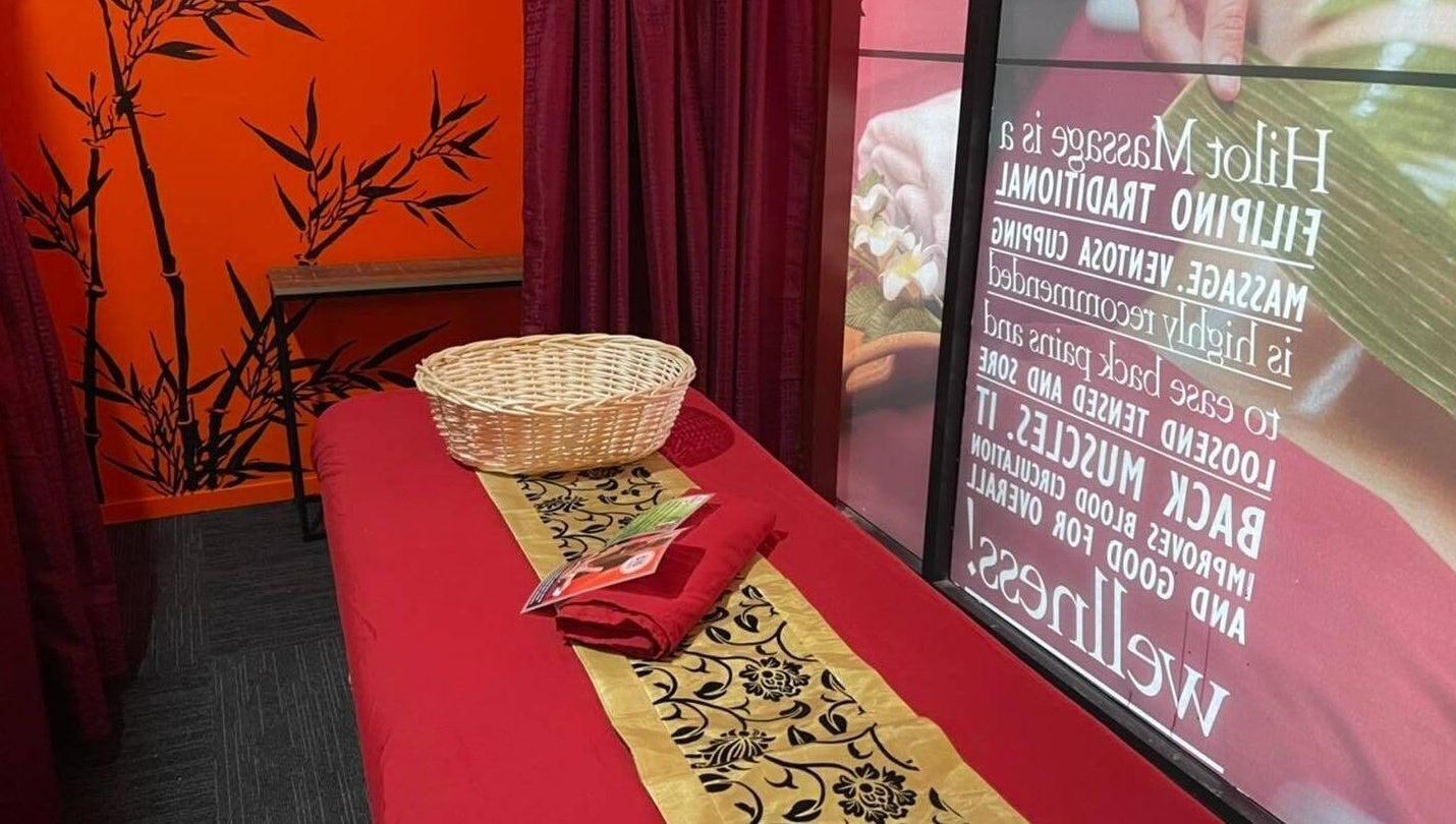 Relaxing massage room at Bamboo Spa Onehunga, Auckland, Auckland, NZ with red decor and bamboo accents.