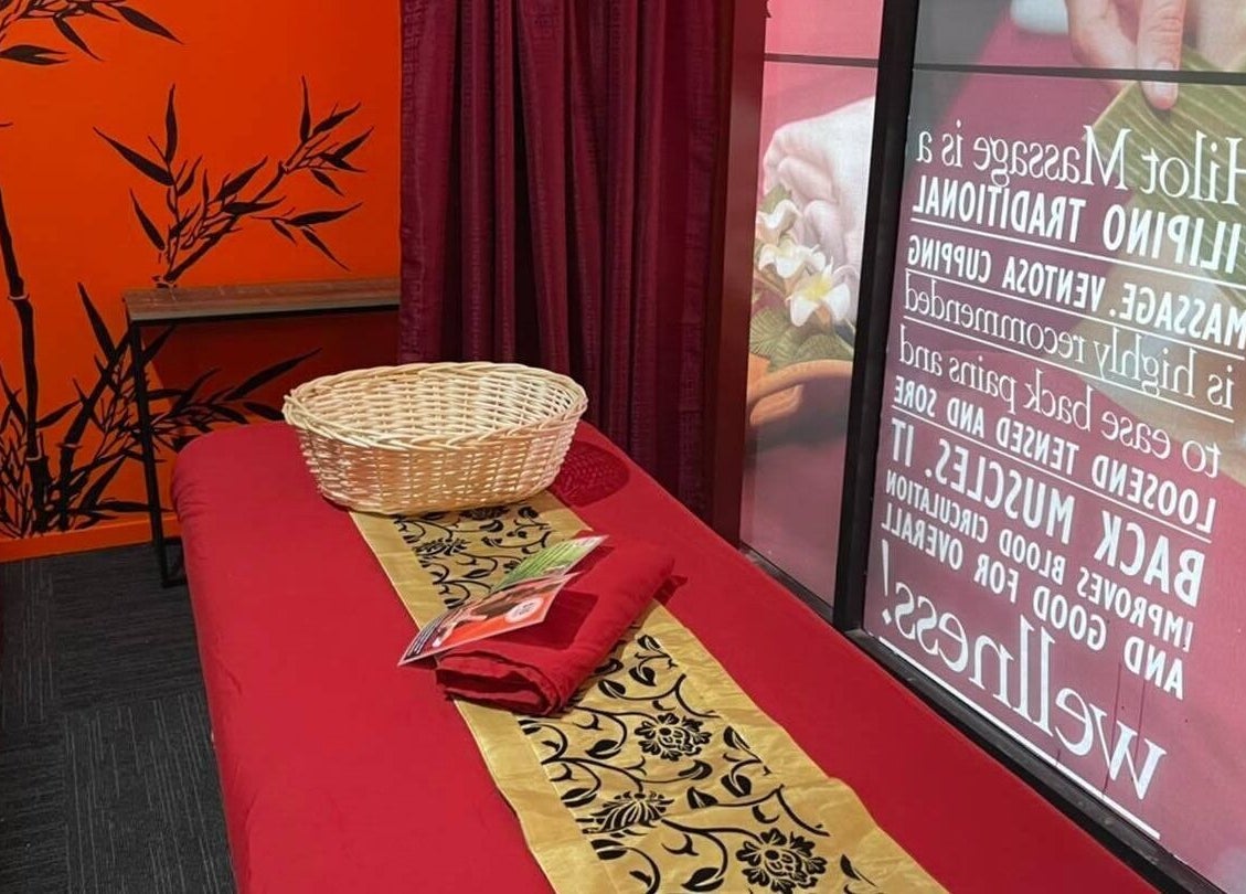 Relaxing massage room at Bamboo Spa Onehunga, Auckland, Auckland, NZ with red decor and bamboo accents.
