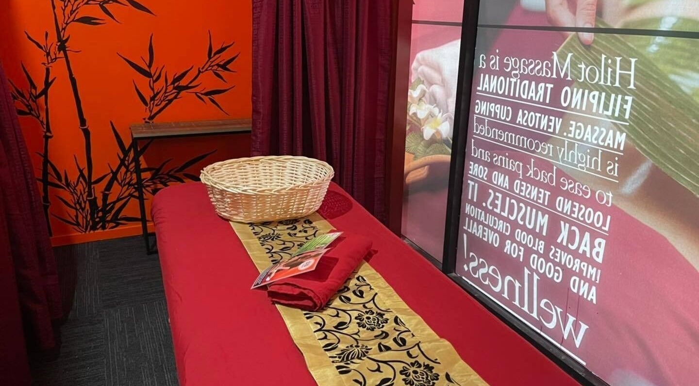 Relaxing massage room at Bamboo Spa Onehunga, Auckland, Auckland, NZ with red decor and bamboo accents.