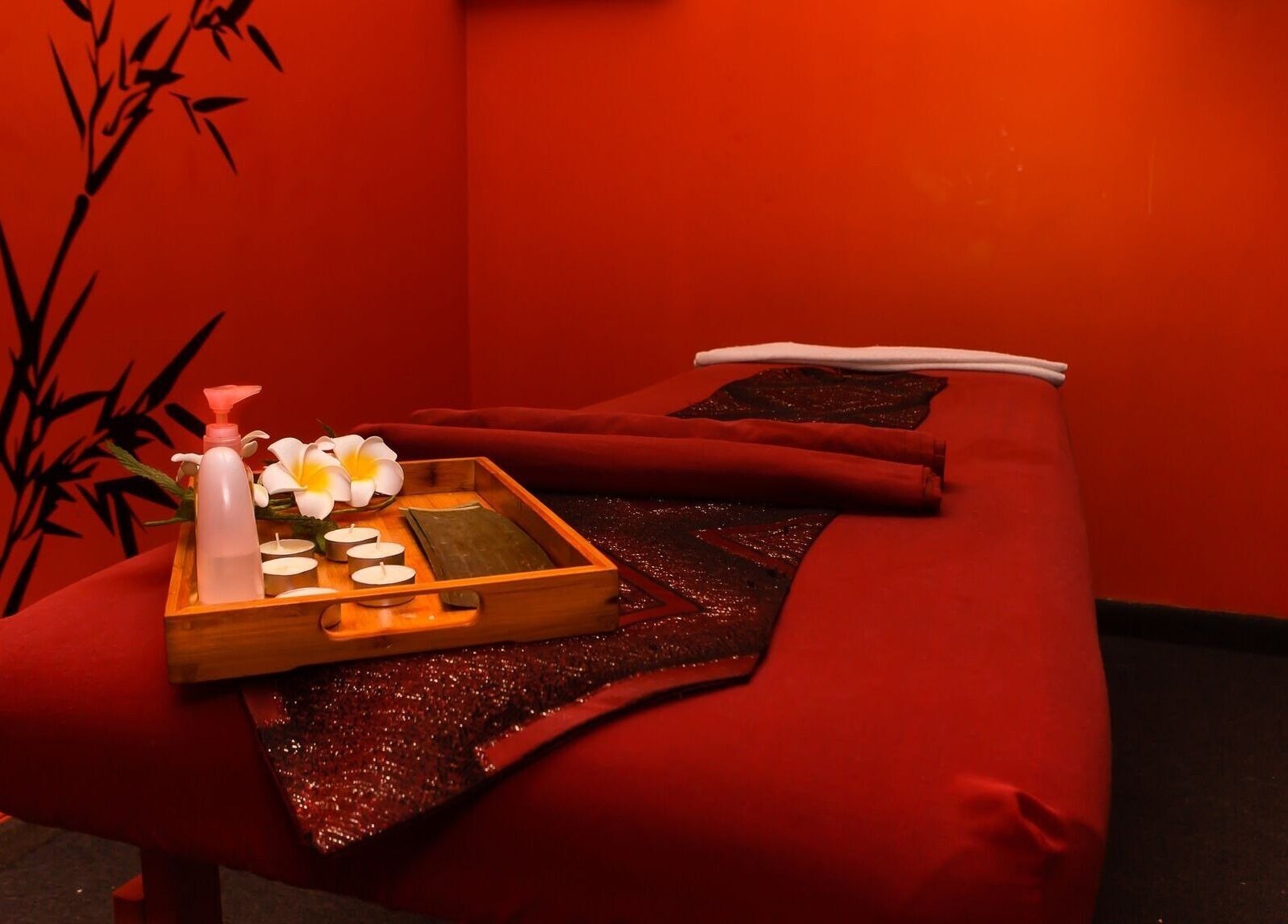 Tranquil therapy room at Bamboo Spa Onehunga, Auckland, Auckland, NZ with red decor and bamboo accents.