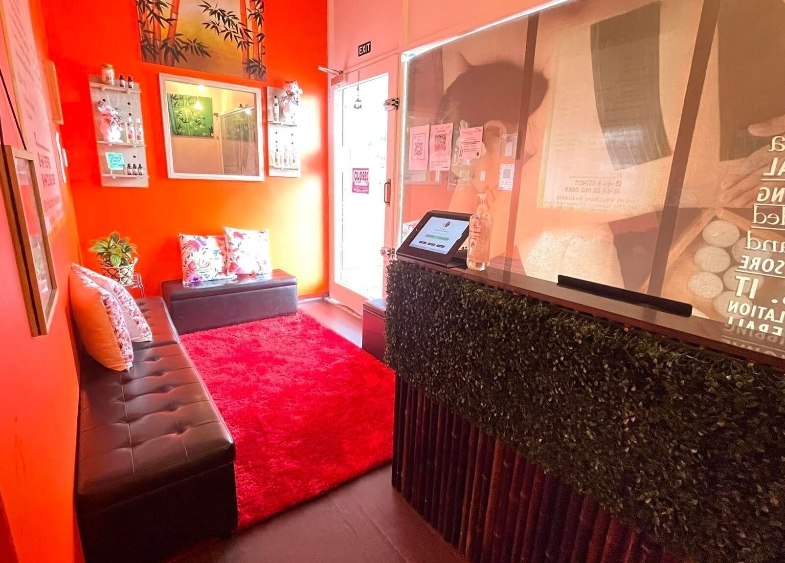 Welcoming lobby of Bamboo Spa Onehunga in Auckland with vibrant decor and lush seating.