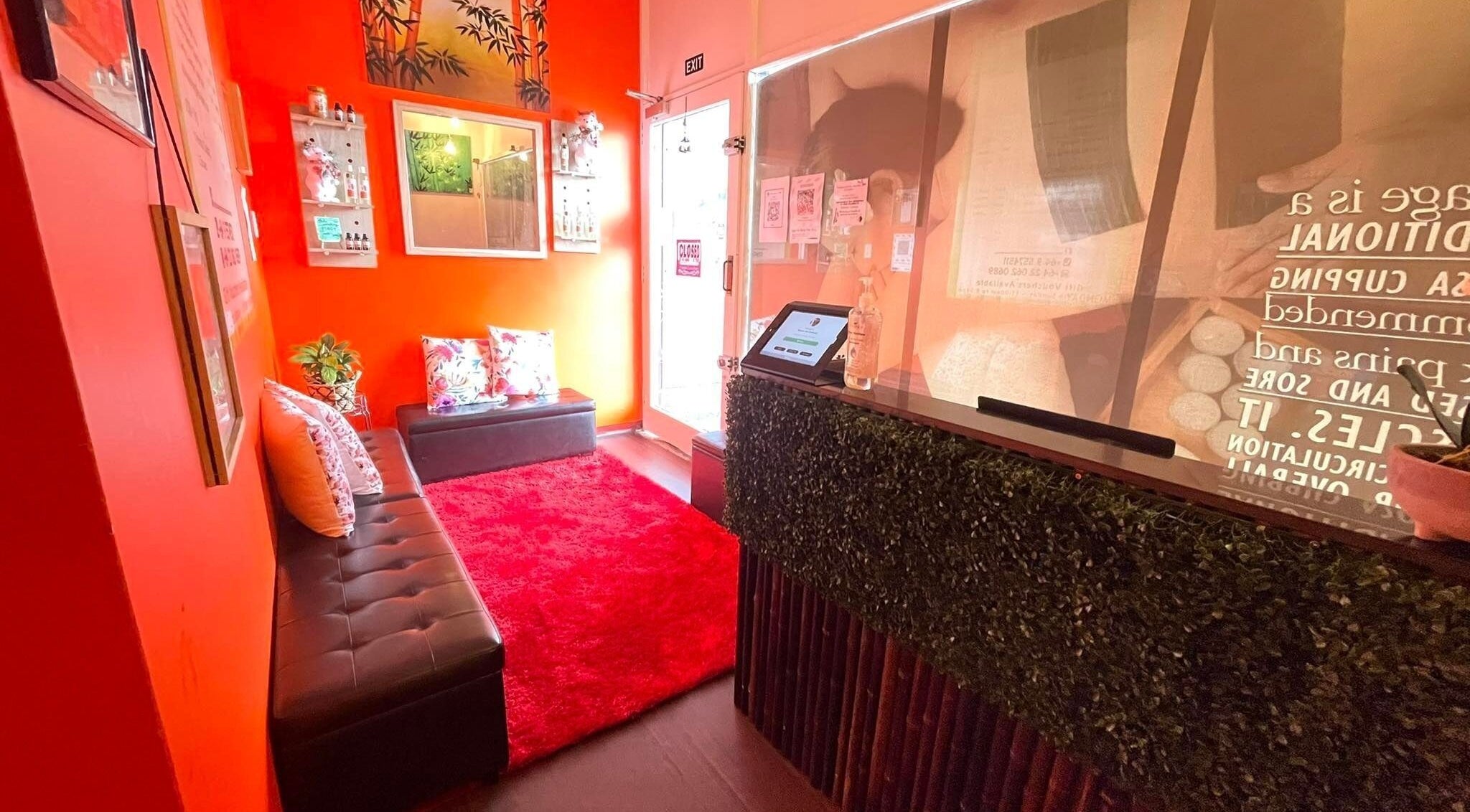 Welcoming lobby of Bamboo Spa Onehunga in Auckland with vibrant decor and lush seating.