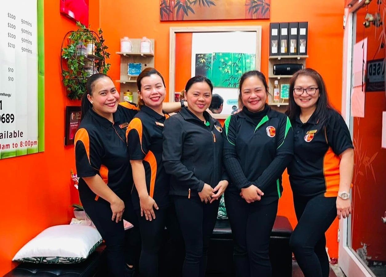 Friendly staff at Bamboo Spa Onehunga, Auckland, NZ standing in a vibrant and welcoming reception area.