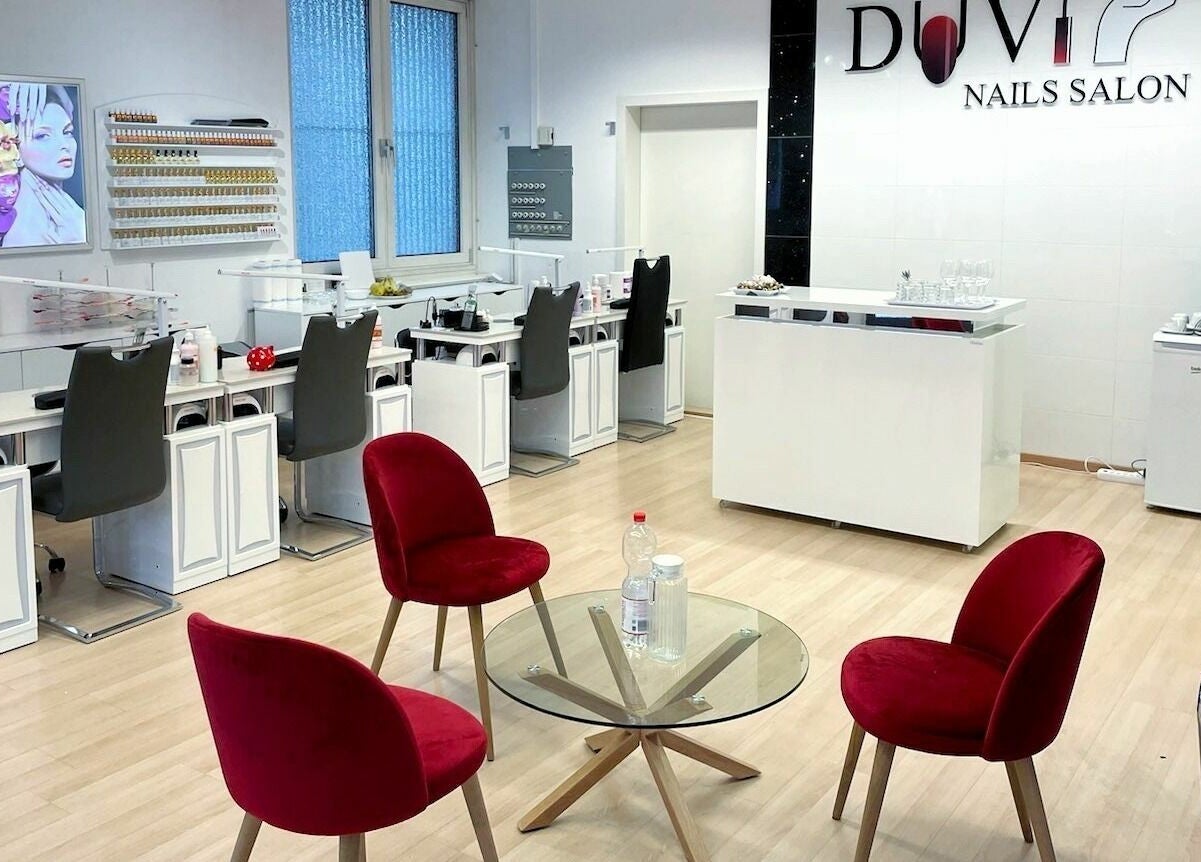 Duvi Nails Salon - Zurich features elegant interior with red chairs and manicure stations. Located in Zürich, Zürich, CH.