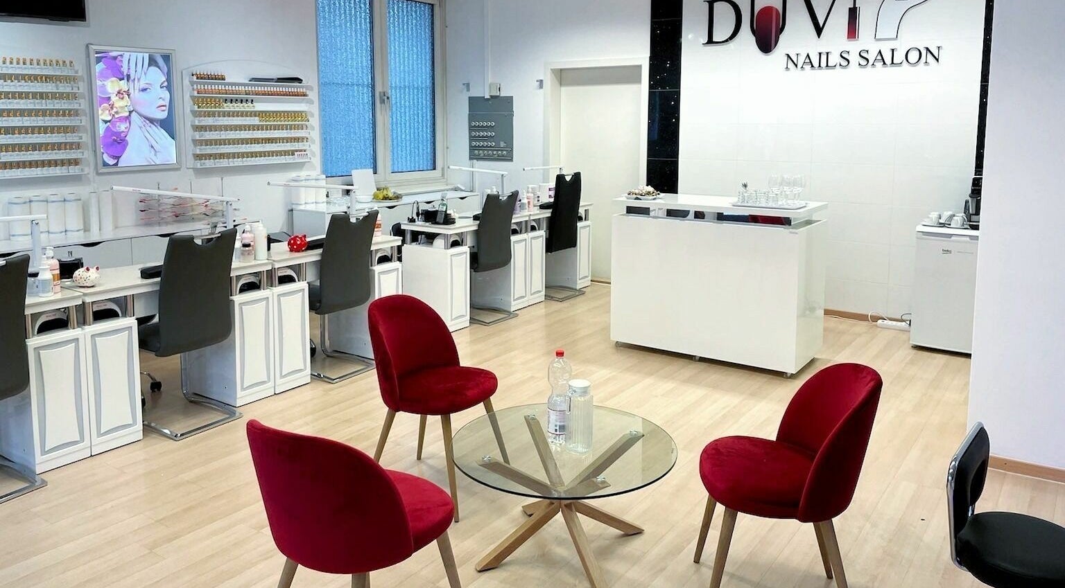 Duvi Nails Salon - Zurich features elegant interior with red chairs and manicure stations. Located in Zürich, Zürich, CH.