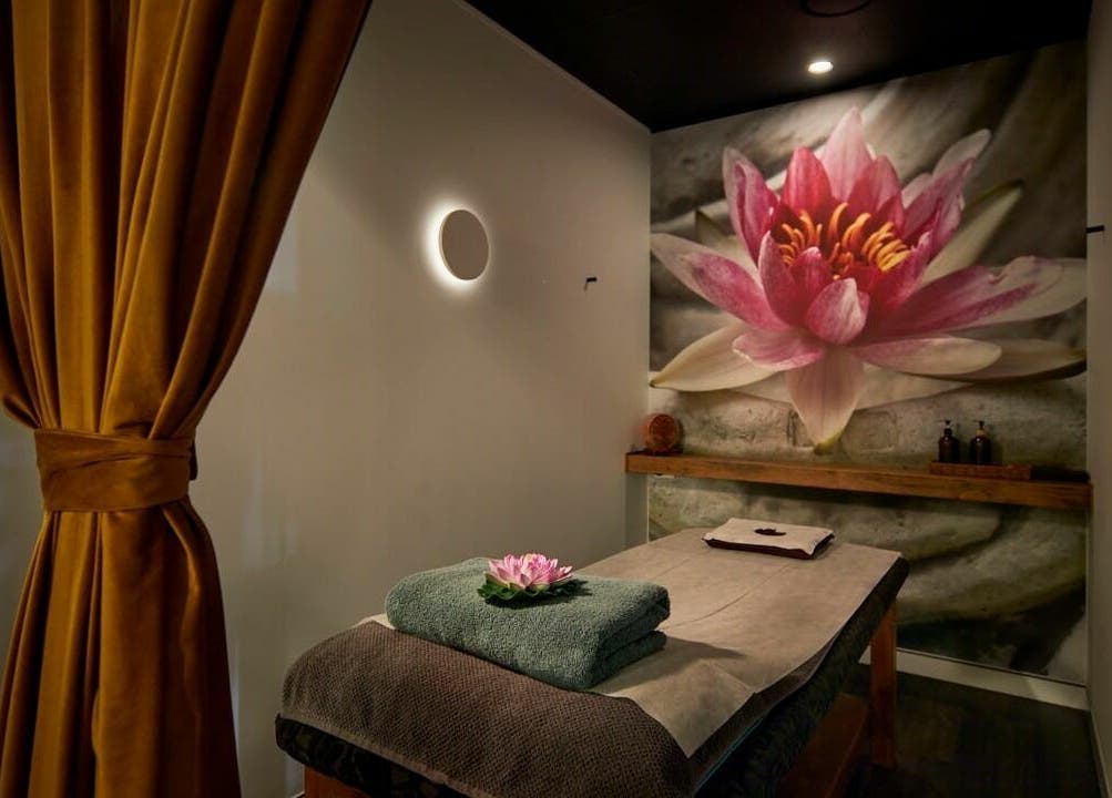Tranquil massage room at Sabai Thai Massage & Spa in Menai, New South Wales, AU, adorned with a lotus mural.