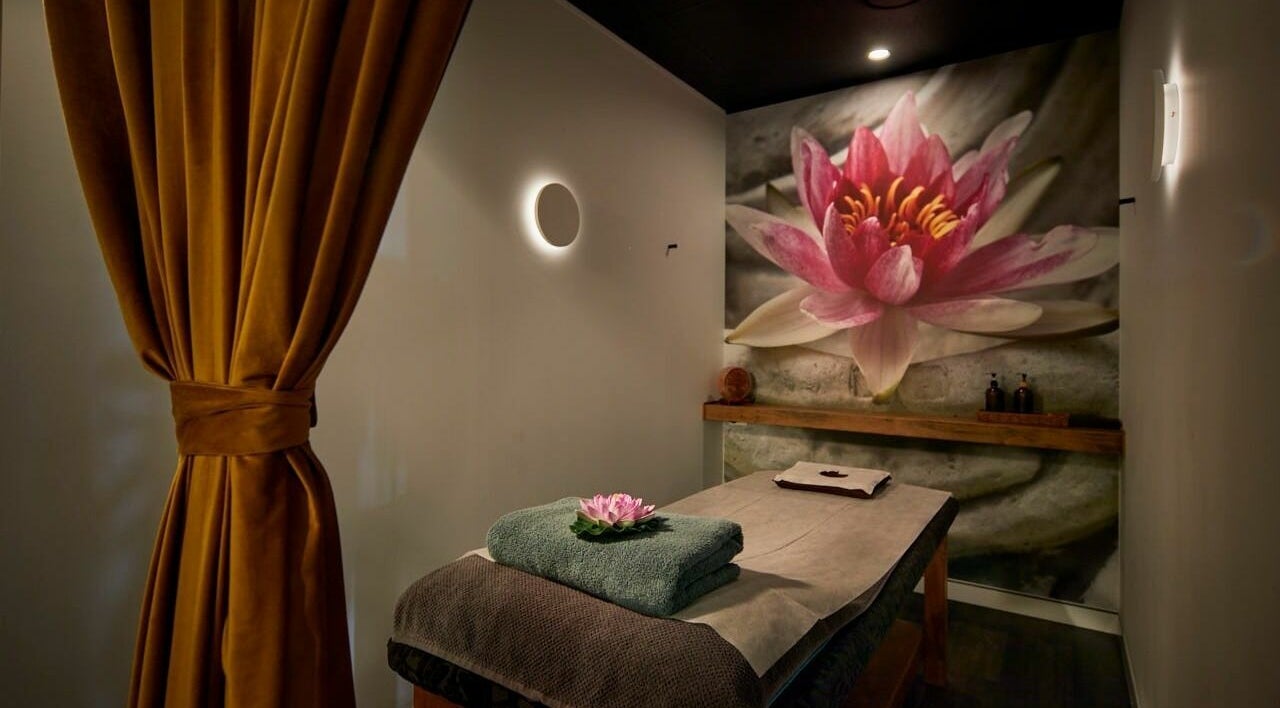 Tranquil massage room at Sabai Thai Massage & Spa in Menai, New South Wales, AU, adorned with a lotus mural.