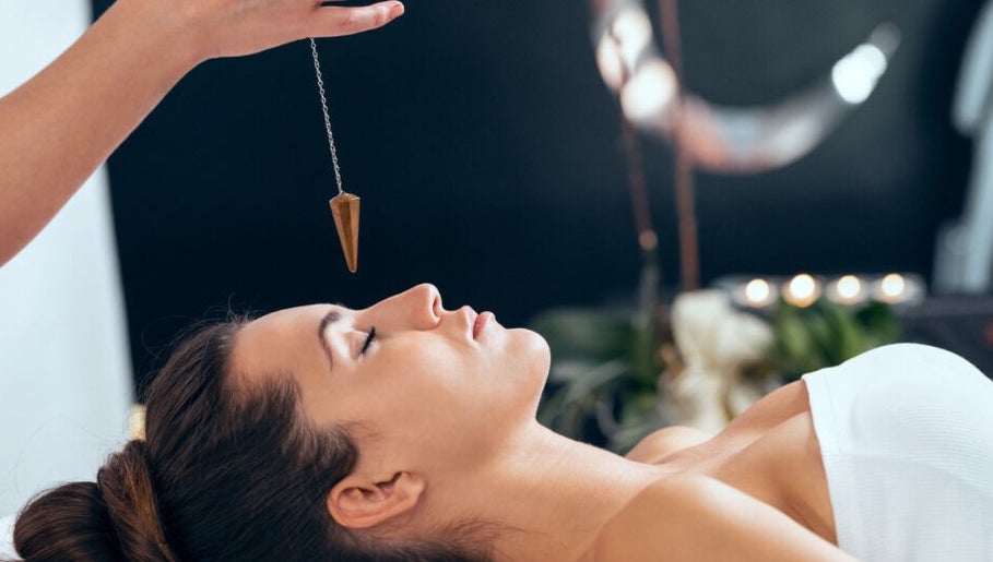 Relaxing hypnosis at Wellness Sanctuary-Mossley, Mossley, England, GB featuring a woman in a calm state with pendulum.