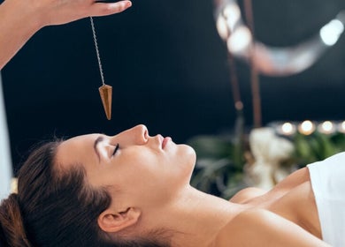 Relaxing hypnosis at Wellness Sanctuary-Mossley, Mossley, England, GB featuring a woman in a calm state with pendulum.