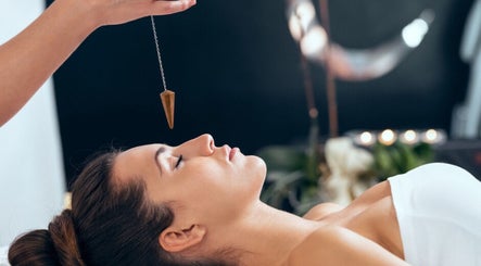 Relaxing hypnosis at Wellness Sanctuary-Mossley, Mossley, England, GB featuring a woman in a calm state with pendulum.