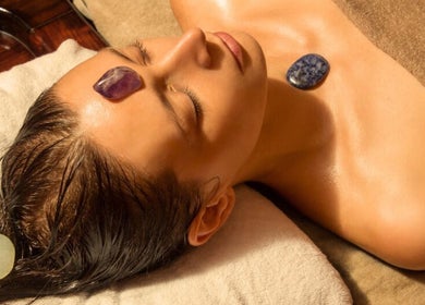Calming crystal therapy at Wellness Sanctuary-Mossley, Mossley, England, GB, featuring gemstones on forehead.