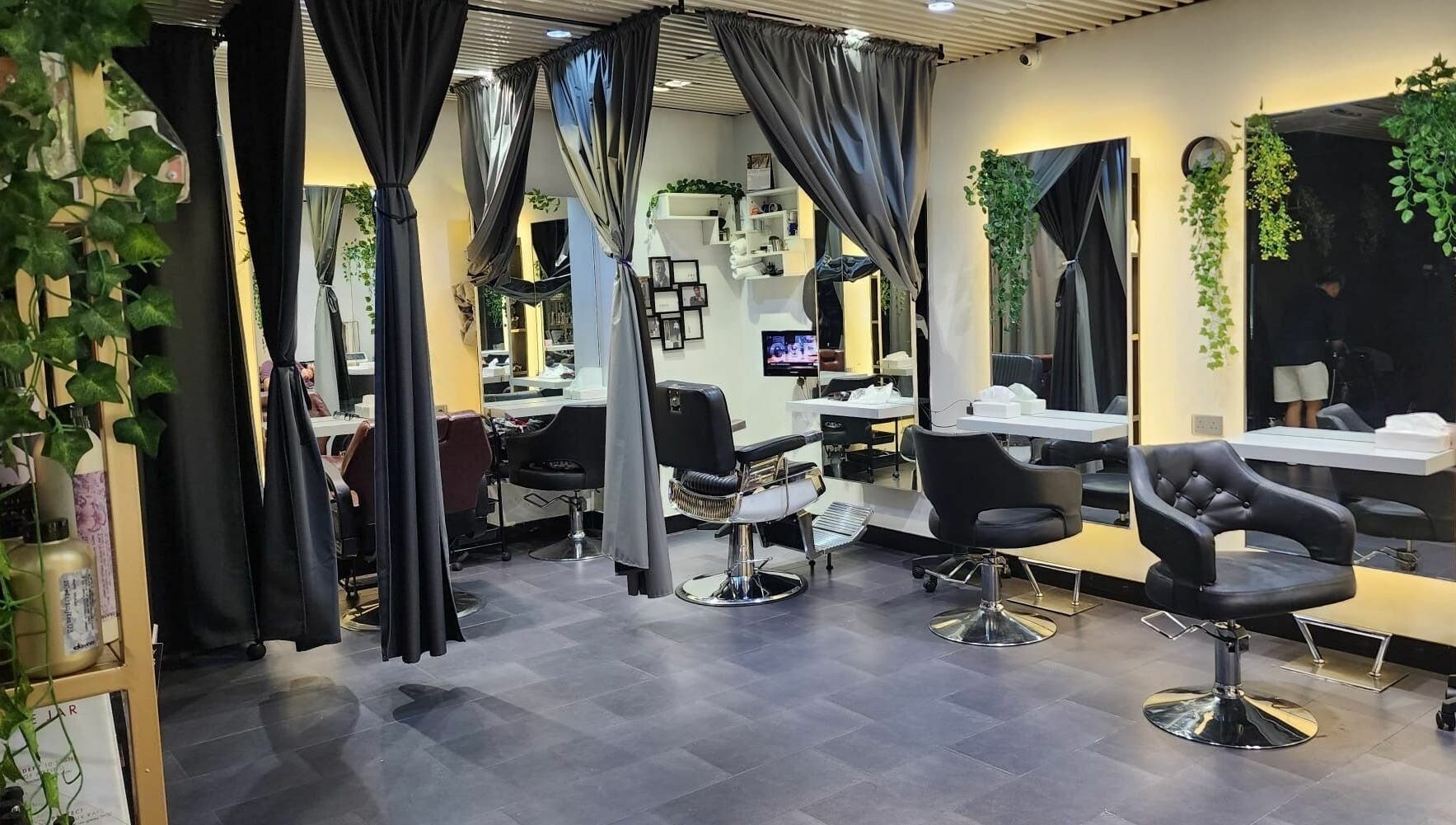 Elegant salon interior at Hair - Riffic, 香港島, 香港島, HK, showcasing modern styling chairs and lush greenery.
