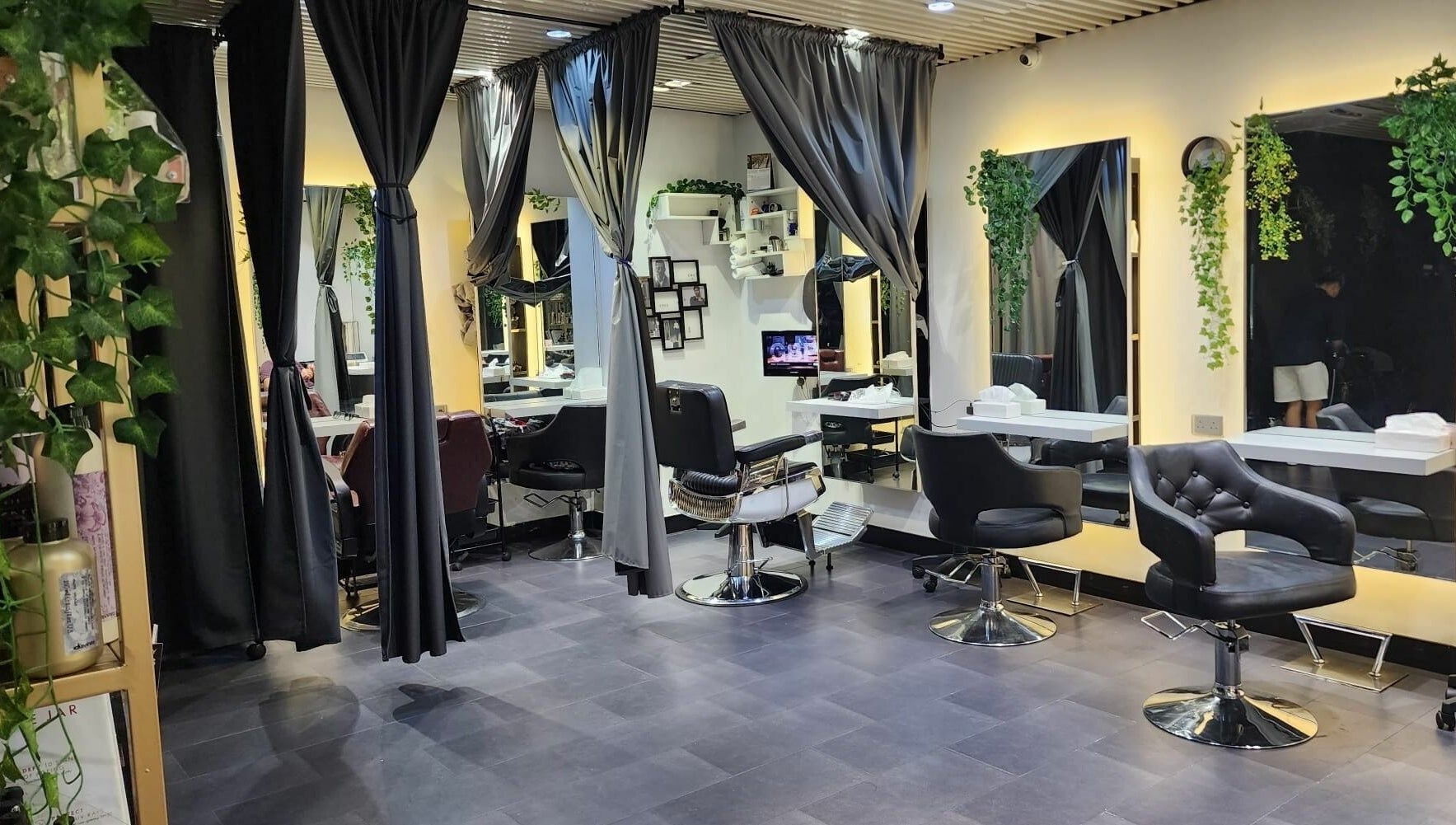 Elegant salon interior at Hair - Riffic, 香港島, 香港島, HK, showcasing modern styling chairs and lush greenery.