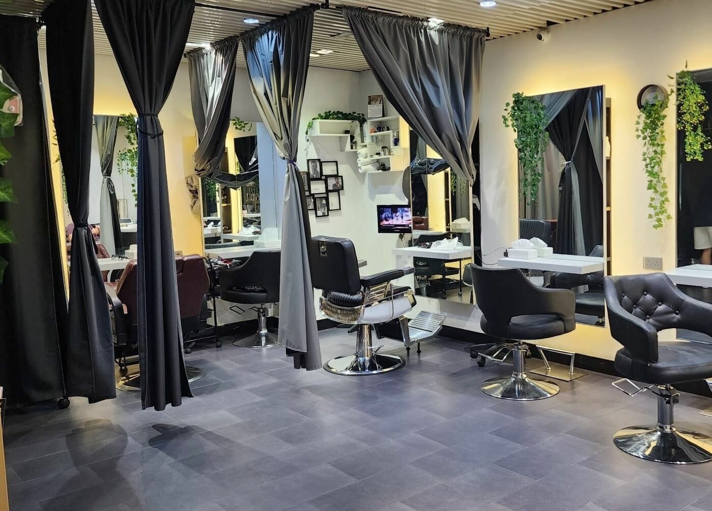 Elegant salon interior at Hair - Riffic, 香港島, 香港島, HK, showcasing modern styling chairs and lush greenery.