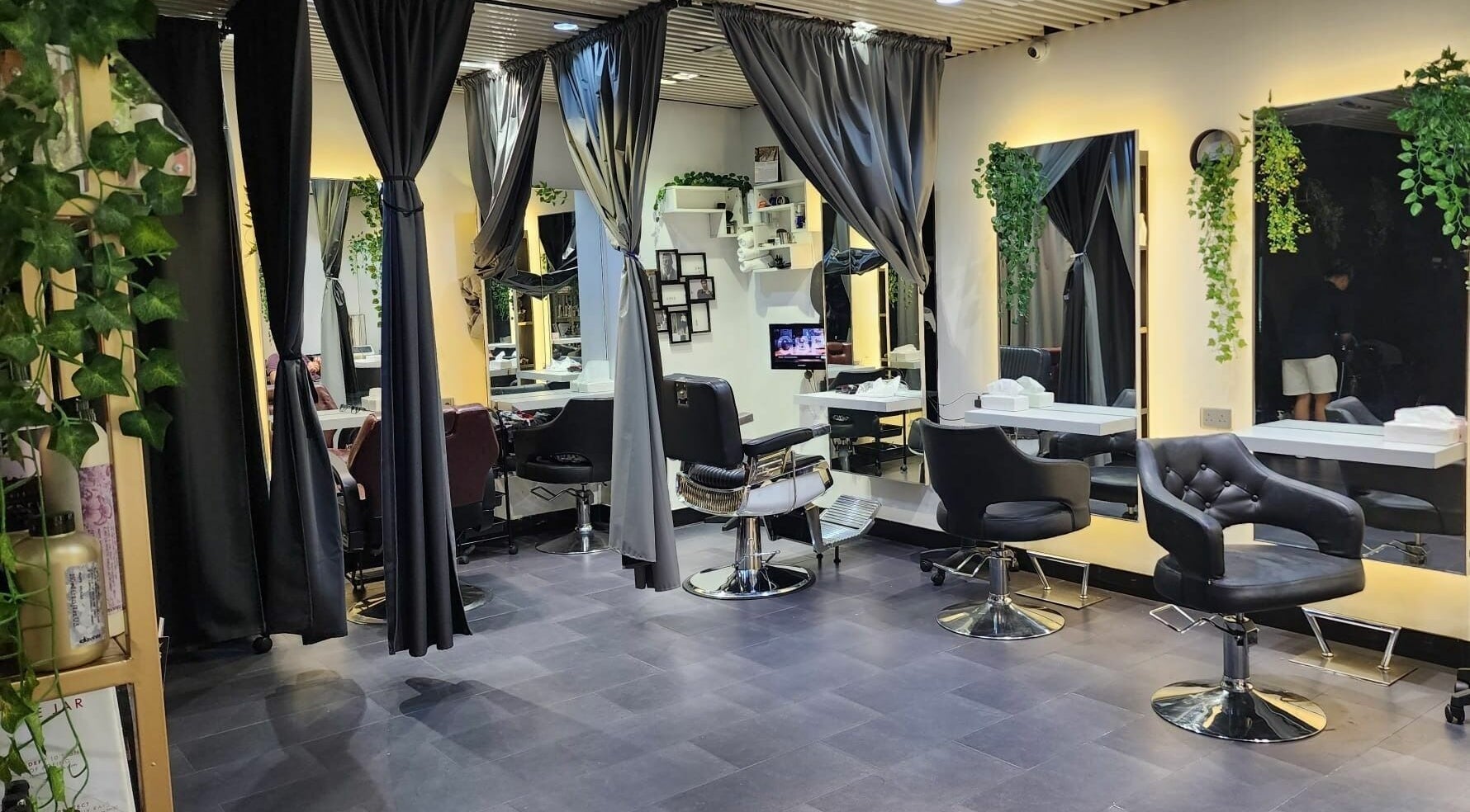 Elegant salon interior at Hair - Riffic, 香港島, 香港島, HK, showcasing modern styling chairs and lush greenery.