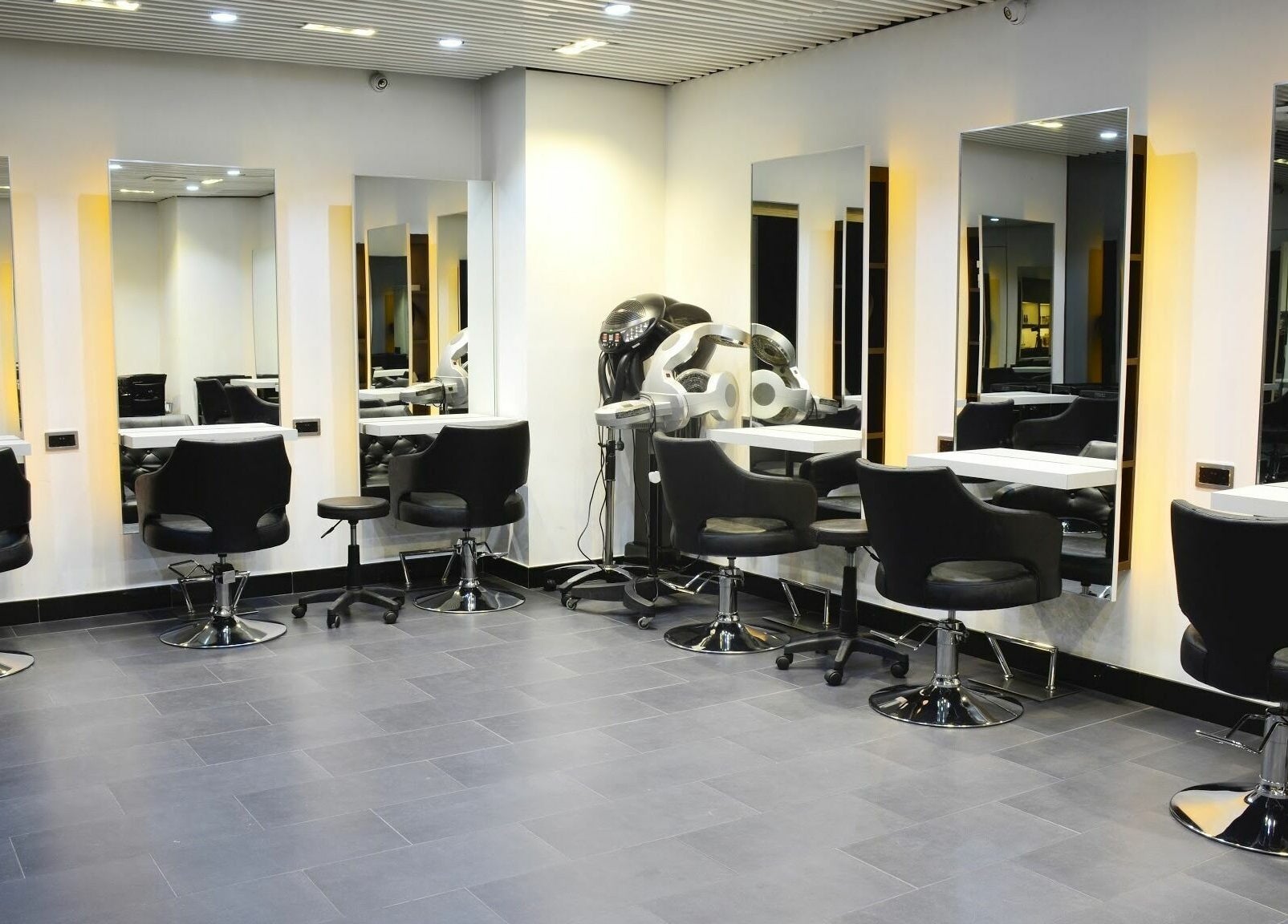 Modern salon interior at Hair - Riffic in 香港島, 香港島, HK with stylish chairs and mirrors.