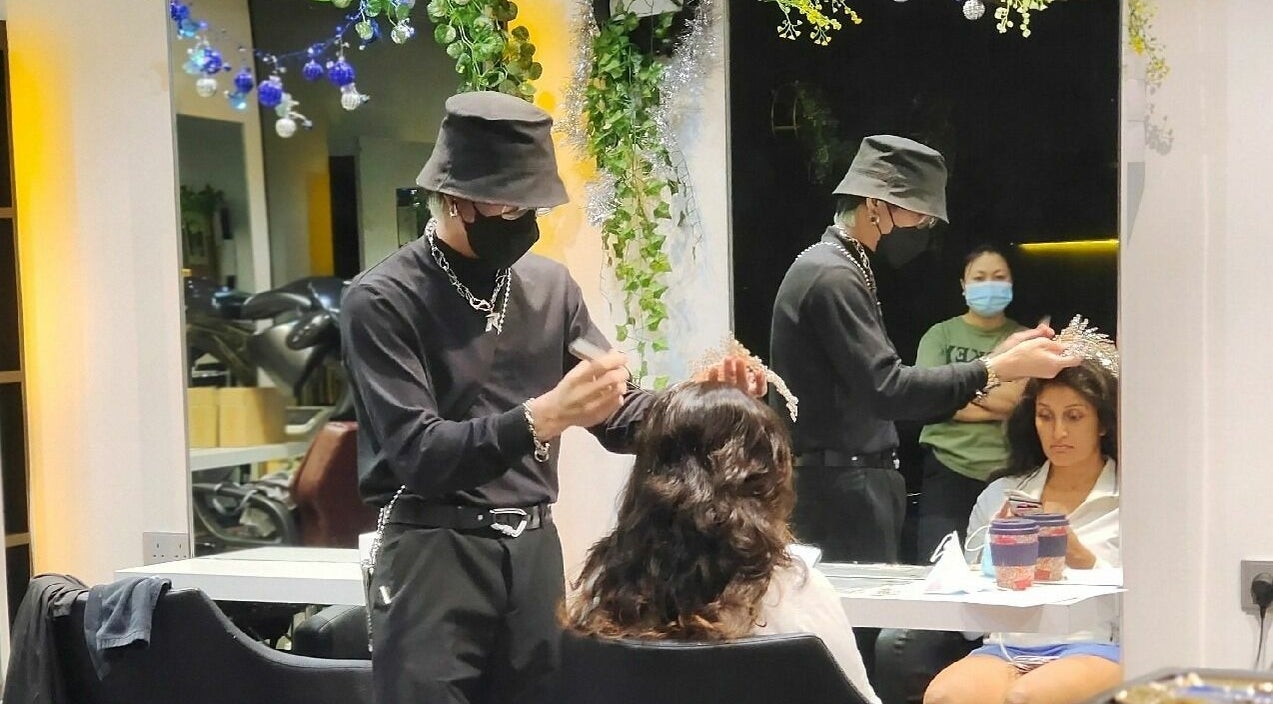 Stylist working on client at Hair - Riffic, 香港島, 香港島, HK, under elegant decor.