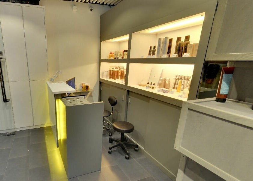 Modern interior of Hair - Riffic in 香港島, HK, showcasing sleek shelves with beauty products.