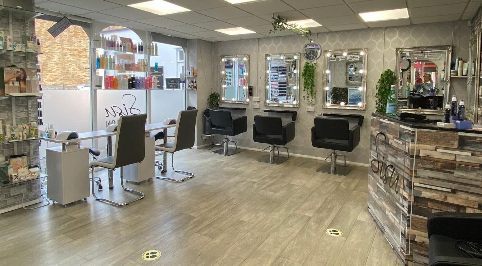Stylish, modern interior of Sisu Salon, Sandbach, England, GB, featuring sleek chairs and illuminated mirrors.