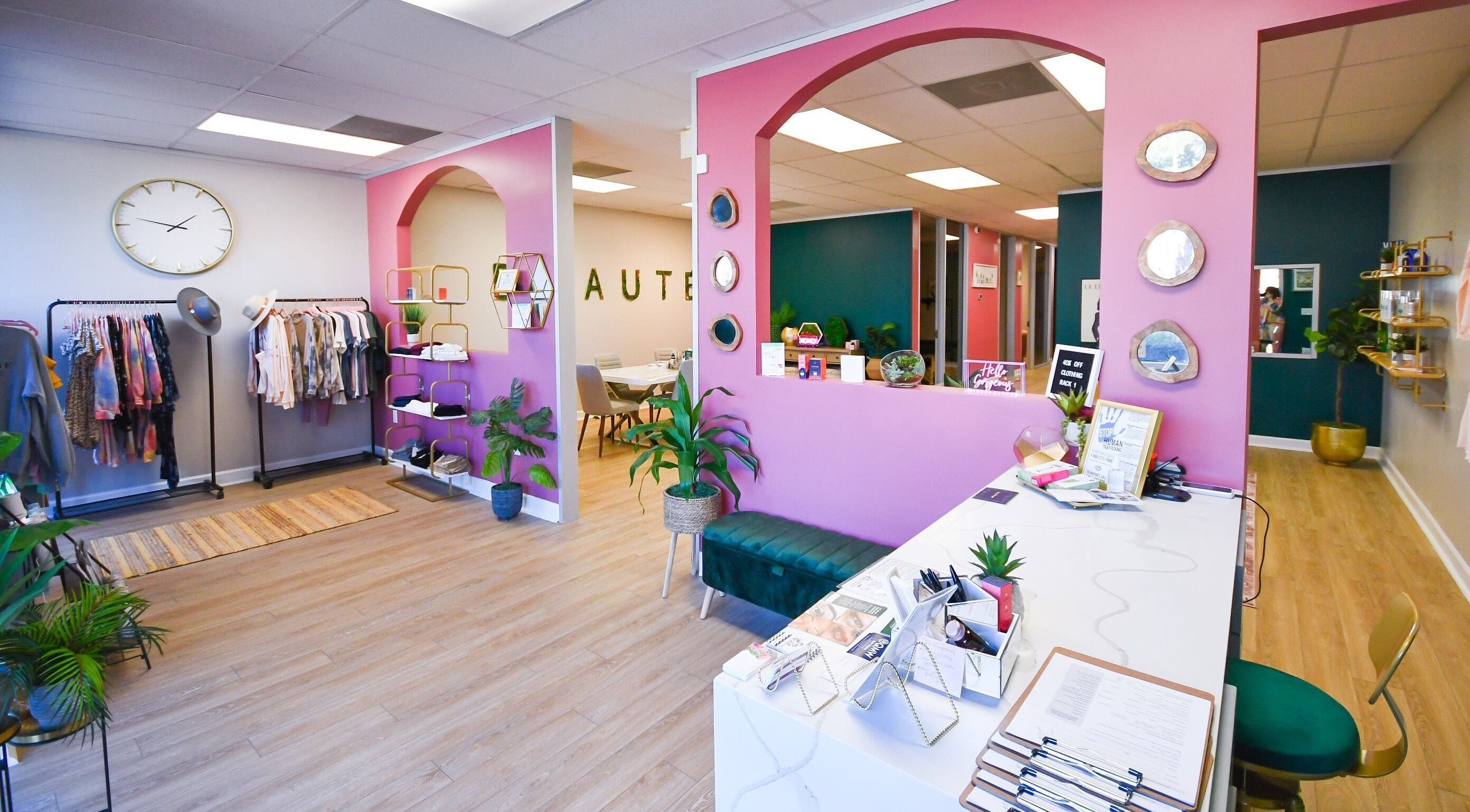 Chic, vibrant interior of The Beaute Compound in The Woodlands, Texas, US showcasing stylish decor and clothing.