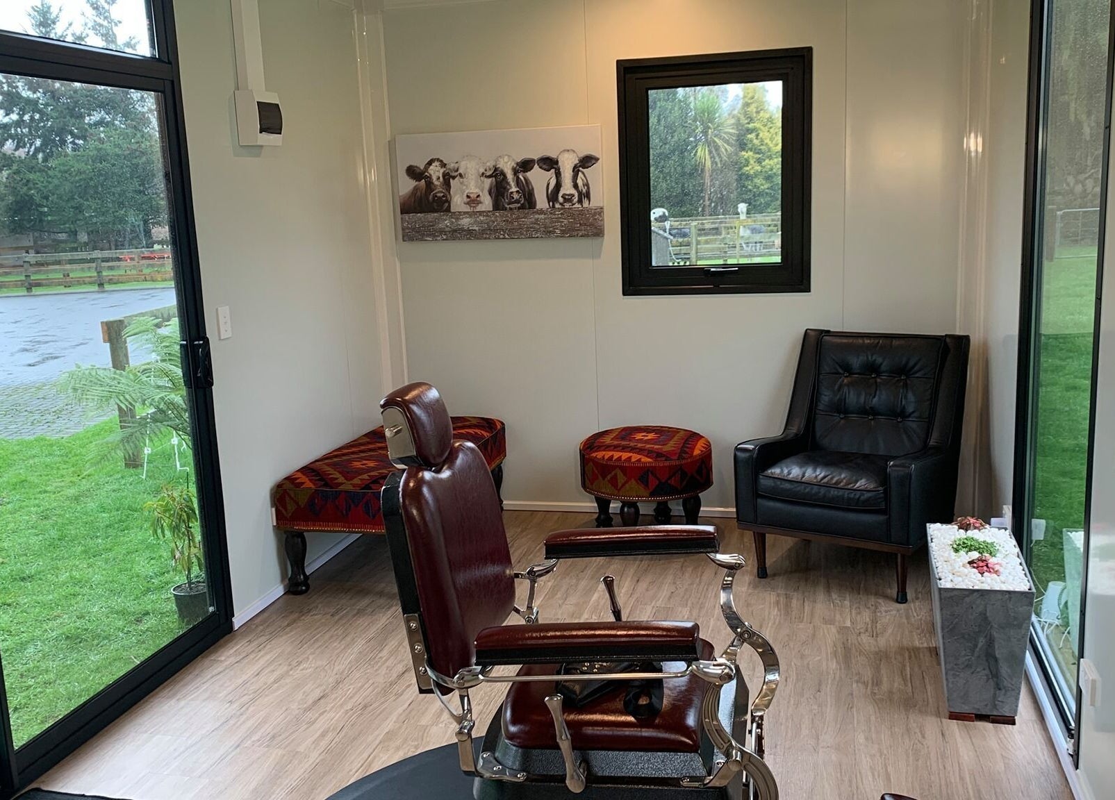 Chic interior of Kaska Kuts Barber in Hamurana, Bay of Plenty, NZ with a classic barber chair and modern decor.