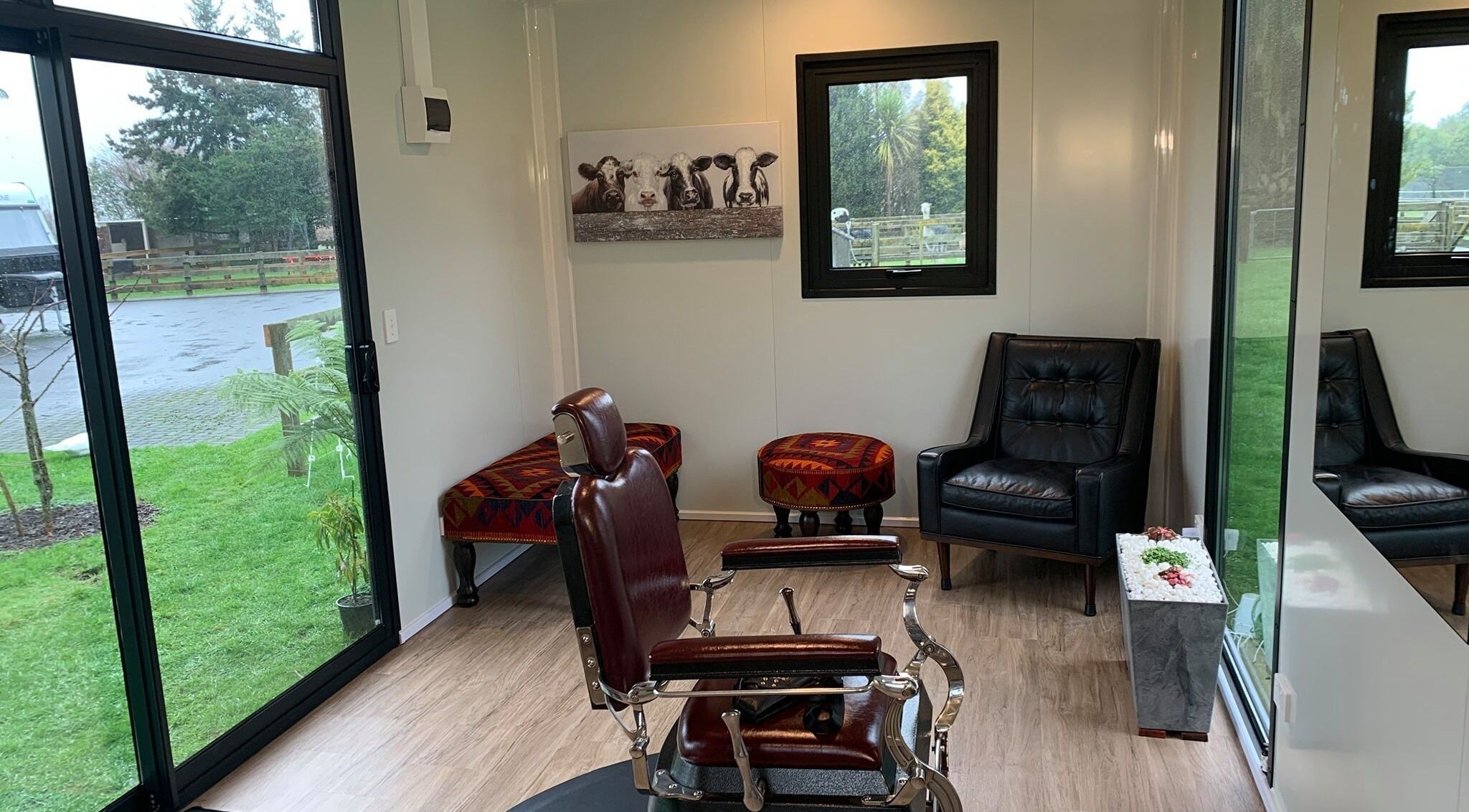 Chic interior of Kaska Kuts Barber in Hamurana, Bay of Plenty, NZ with a classic barber chair and modern decor.