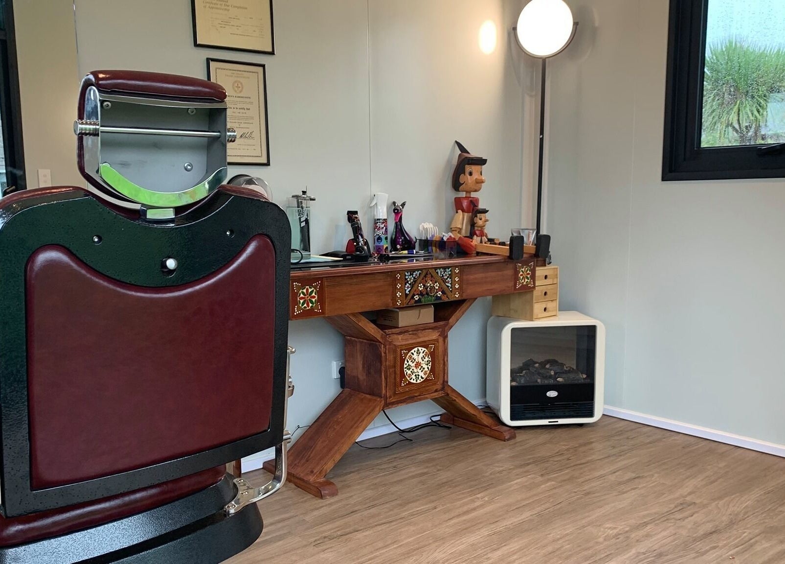Rustic interior at Kaska Kuts Barber in Hamurana, Bay of Plenty, NZ featuring classic barber chair and wooden decor.