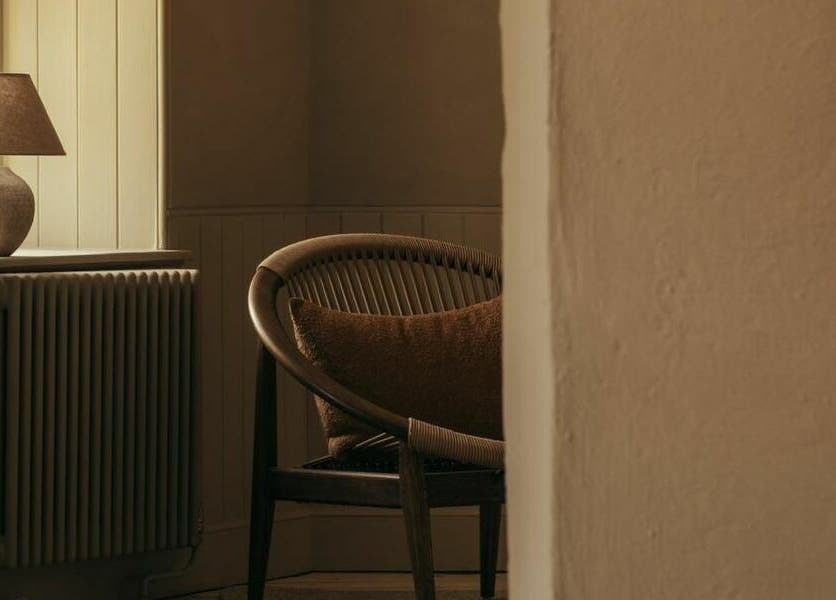 Warm, inviting corner at Buff St Ninian's Manse, Edinburgh, Scotland, GB with an armchair and lamp.