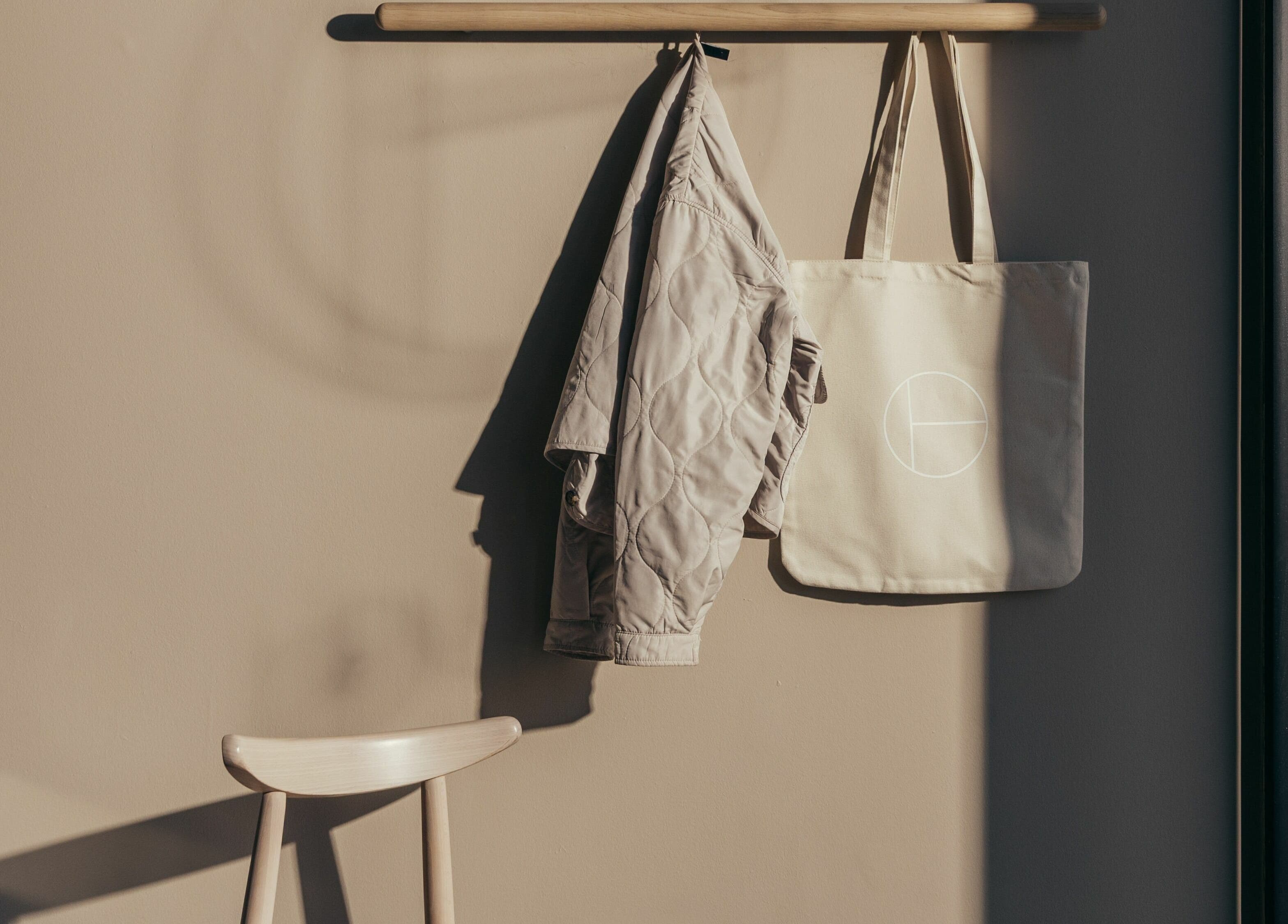 Coat and bag hang in serene corner of Buff Concept Store in Edinburgh, Scotland, GB.