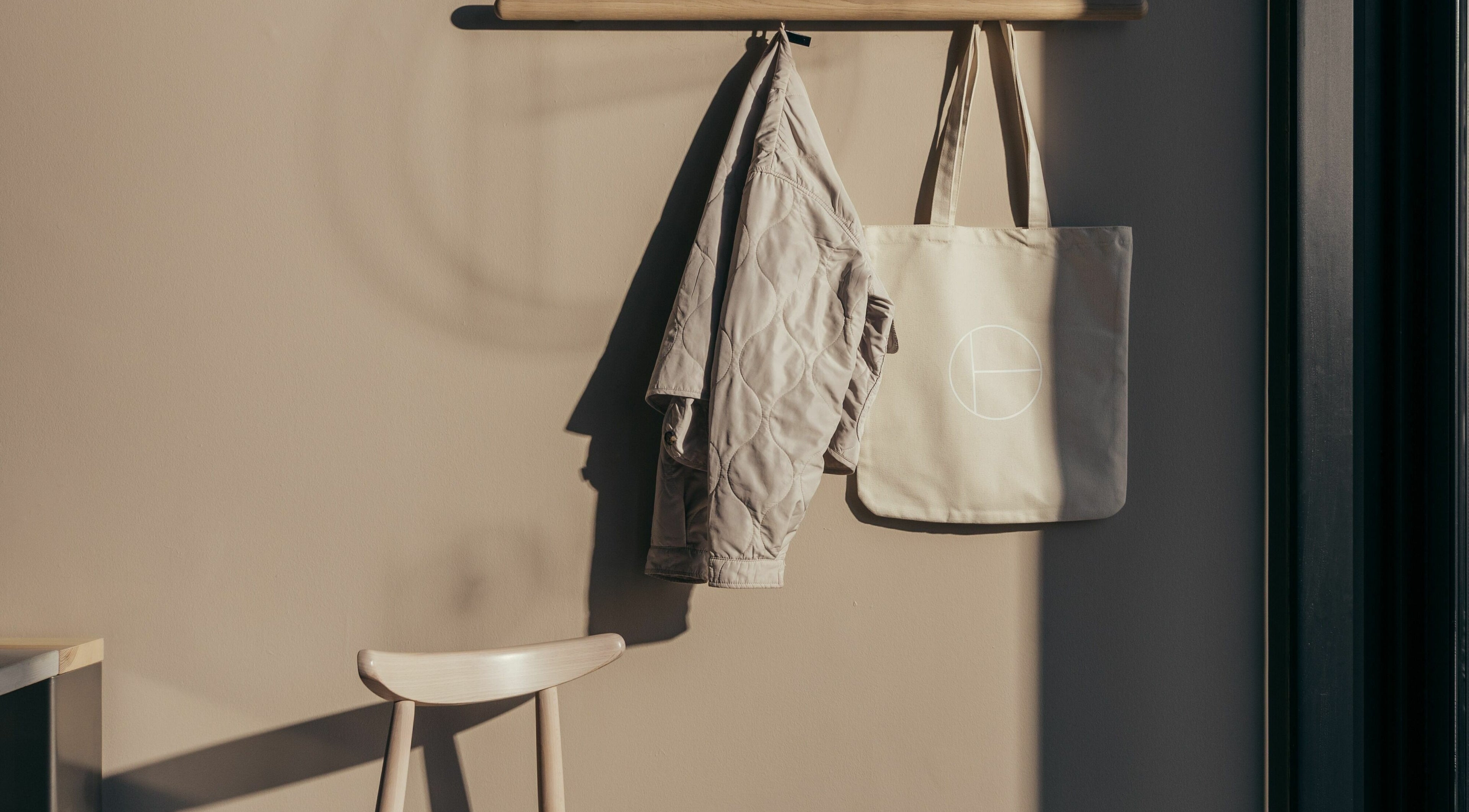 Coat and bag hang in serene corner of Buff Concept Store in Edinburgh, Scotland, GB.