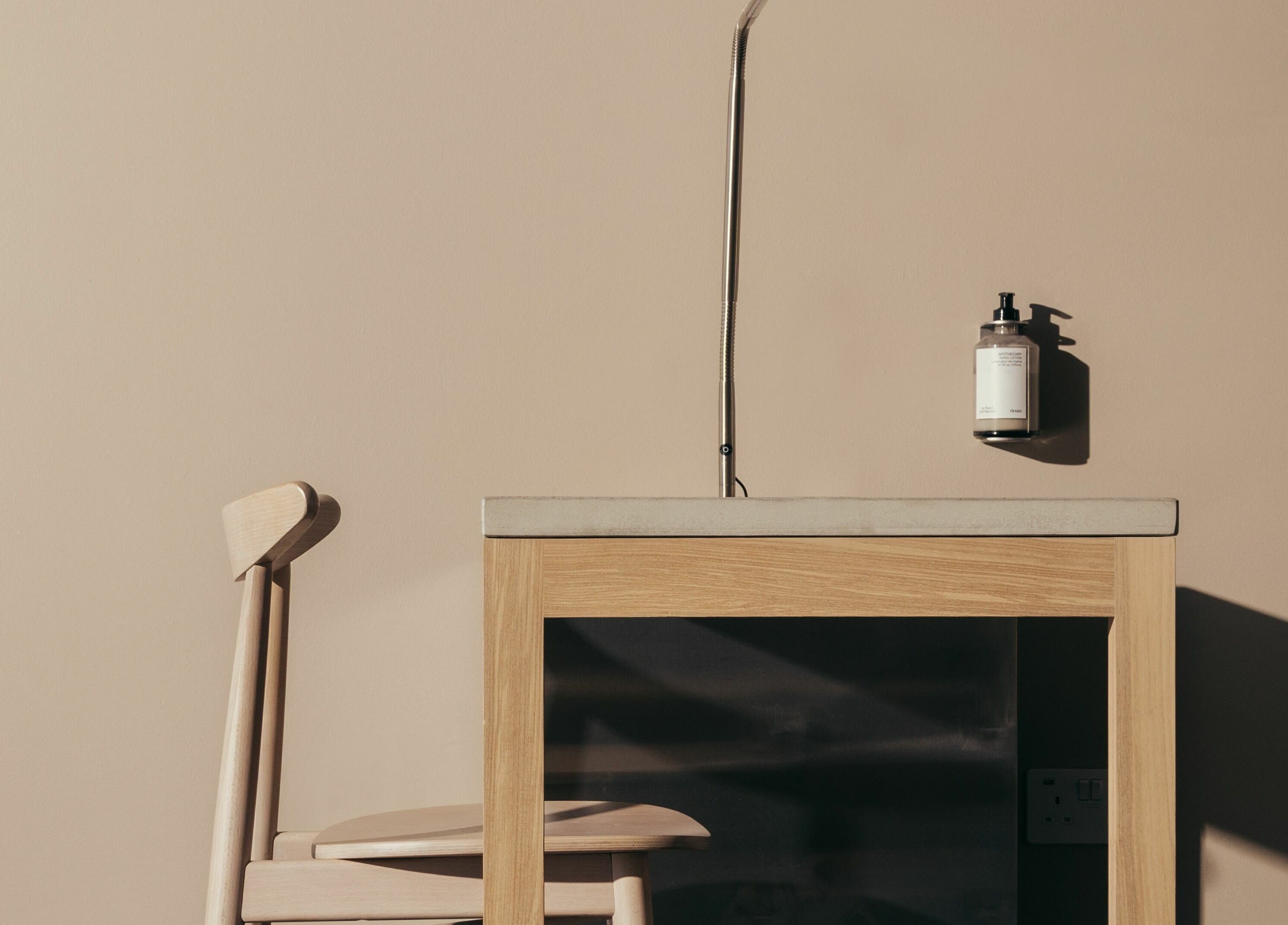 Minimalist beauty setup at Buff Concept Store in Edinburgh, Scotland, GB featuring a wooden chair and table.